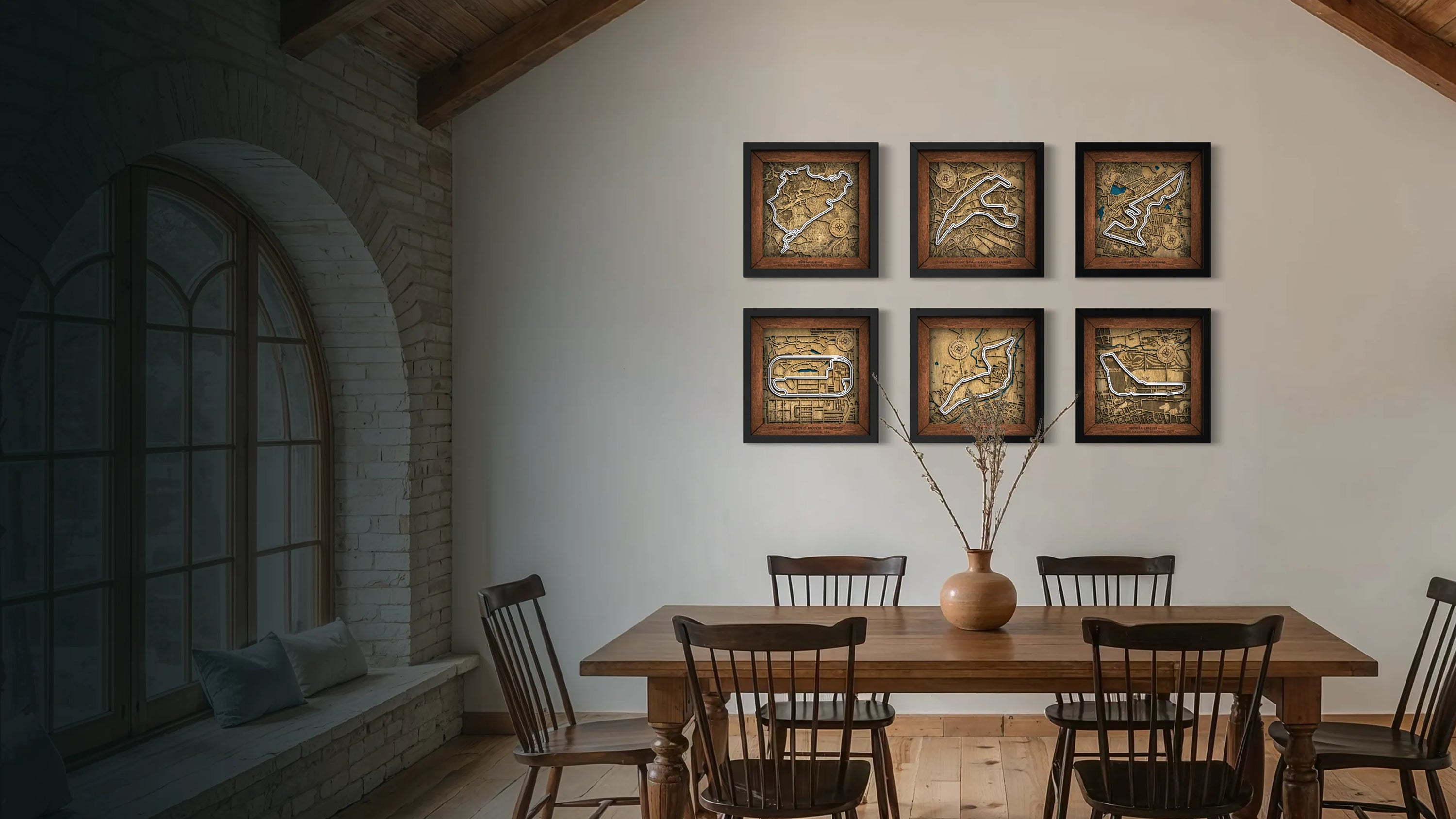 Dining room with wooden table and chairs, and framed artwork on the wall.