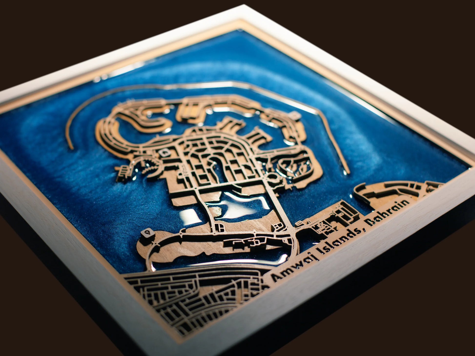 Close-up of the layered wood construction and precision laser engraving of the Amwaj Islands wall art.