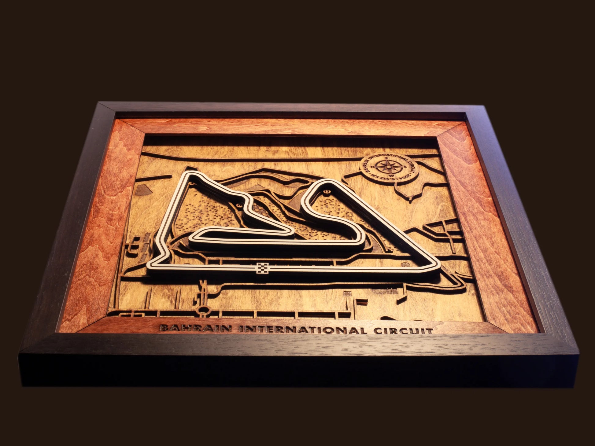Close-up of the handcrafted layered wood construction and fine details of the Bahrain International Circuit wall art.