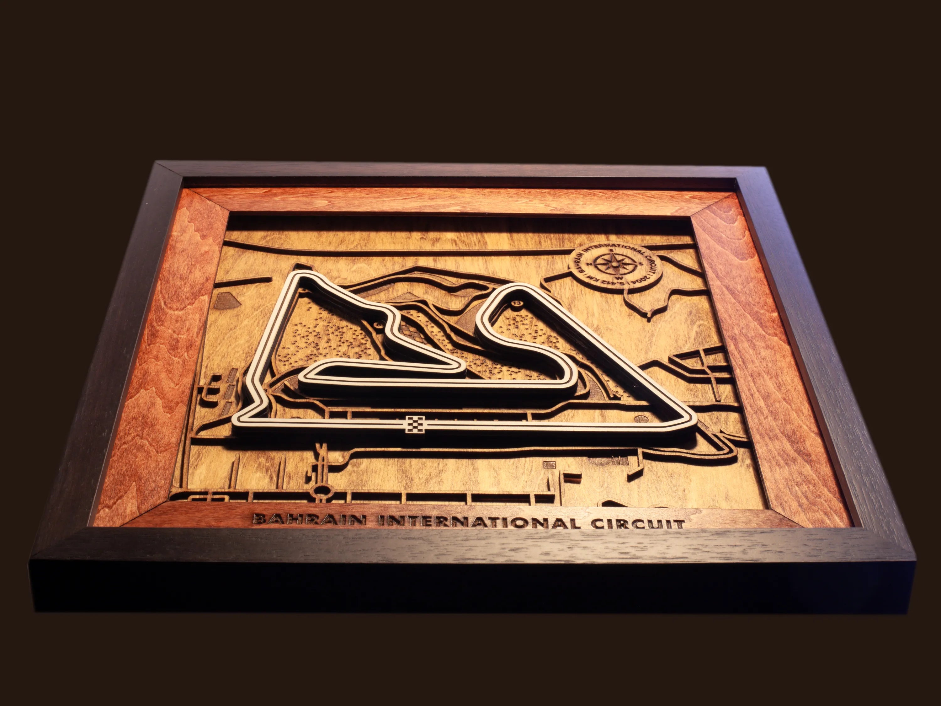 Close-up of the handcrafted layered wood construction and fine details of the Bahrain International Circuit wall art.