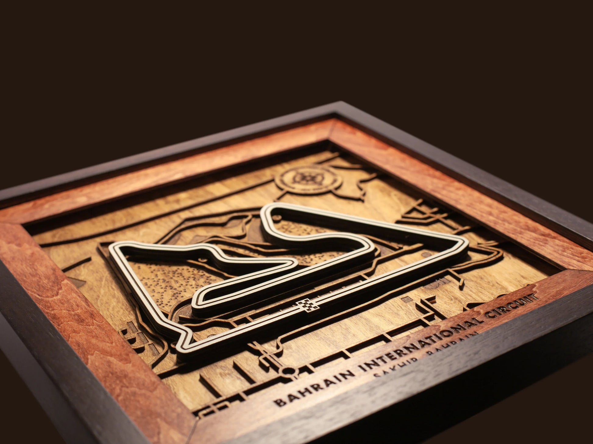 Close-up of the handcrafted layered wood construction and fine details of the Bahrain International Circuit wall art.