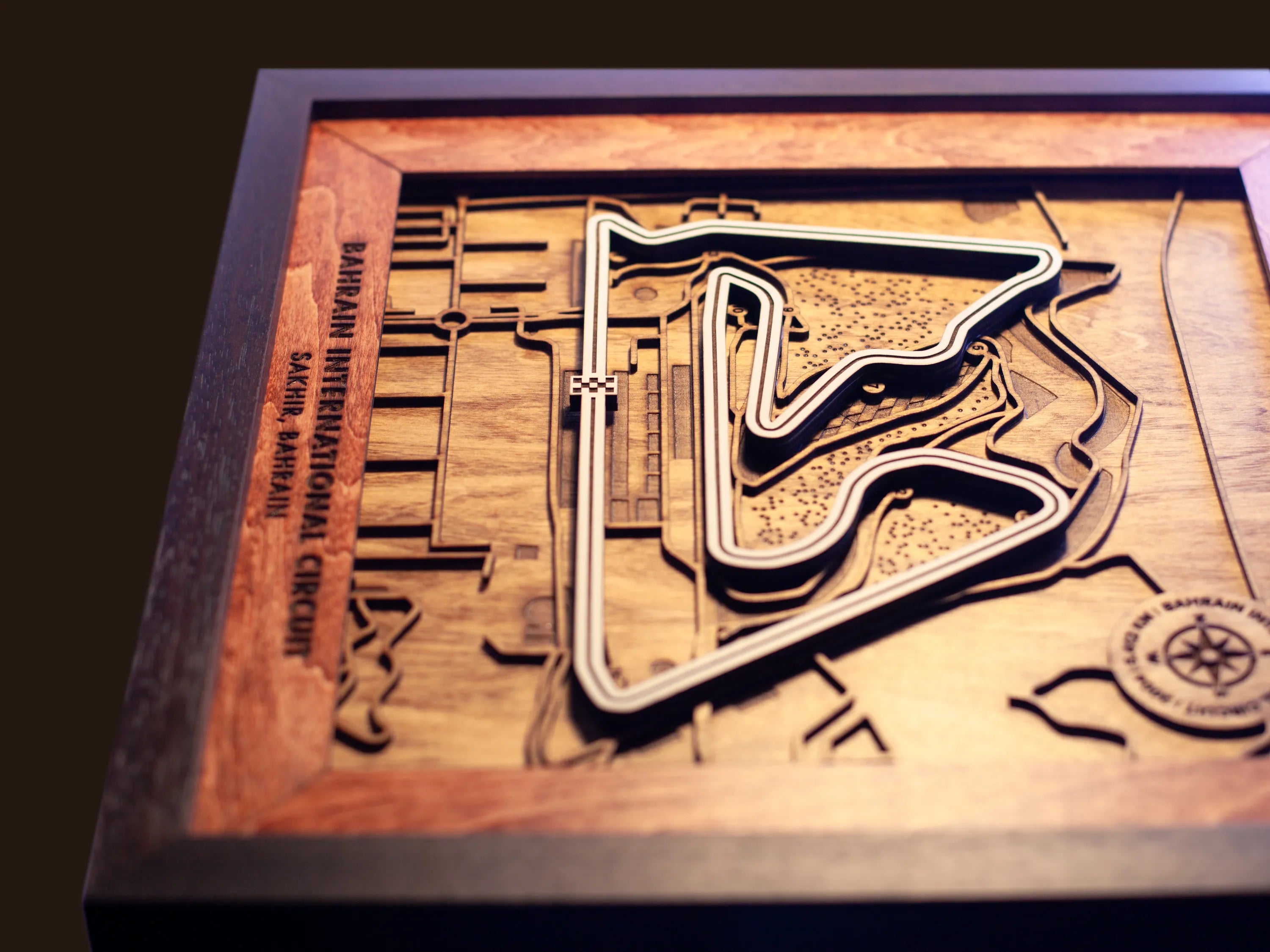 Close-up of the handcrafted layered wood construction and fine details of the Bahrain International Circuit wall art.