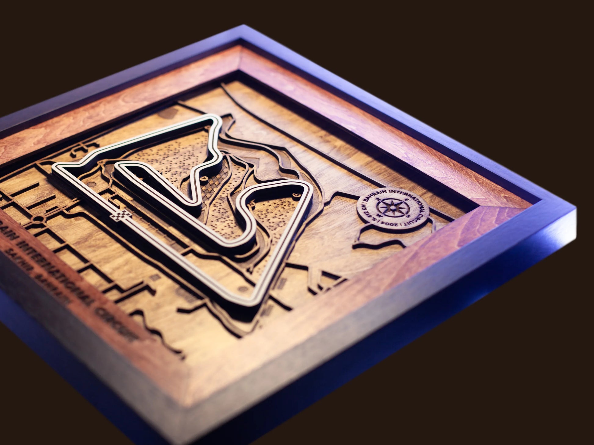 Close-up of the handcrafted layered wood construction and fine details of the Bahrain International Circuit wall art.