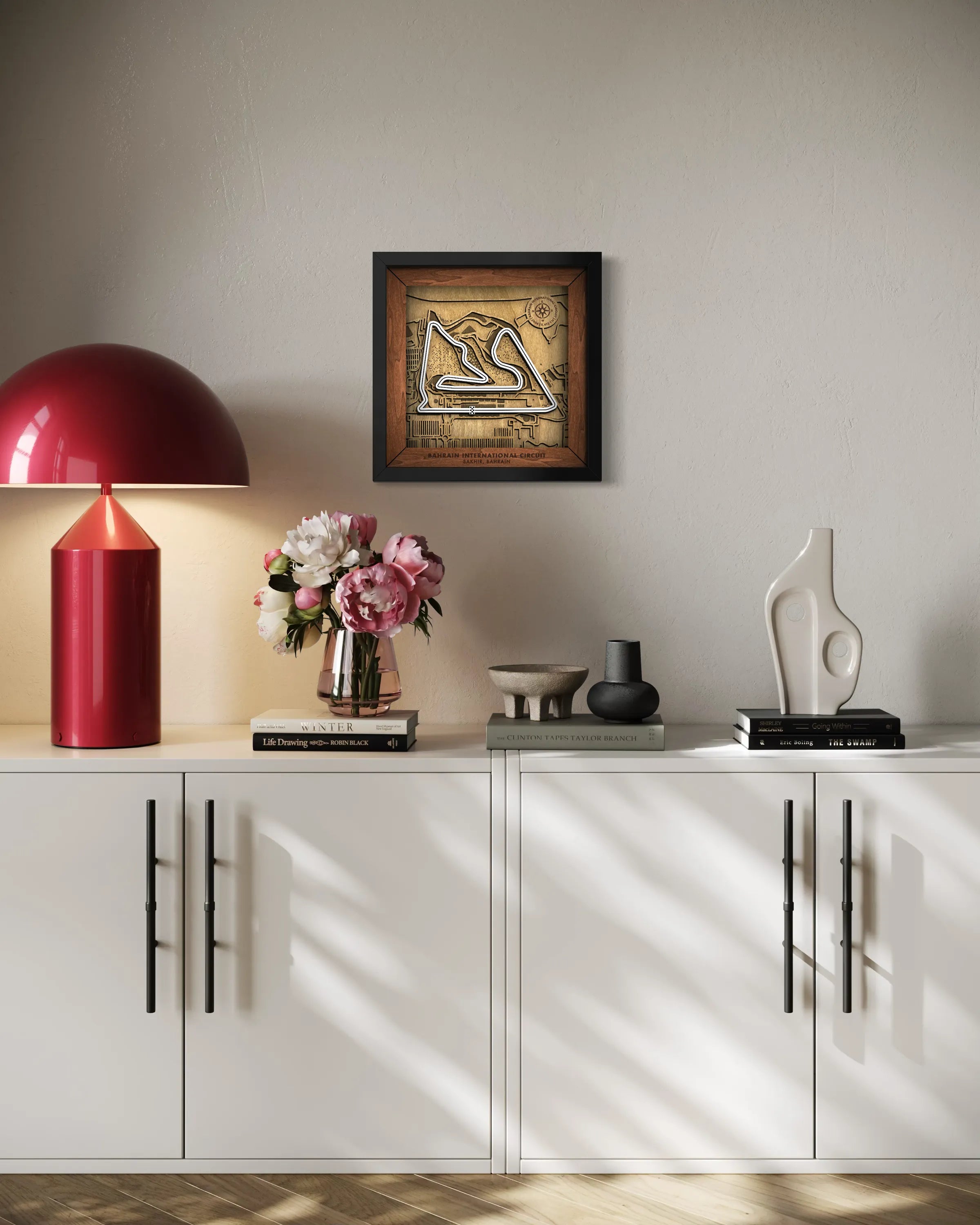 Handcrafted Bahrain International Circuit layered wooden racetrack wall art displayed in a modern living room.