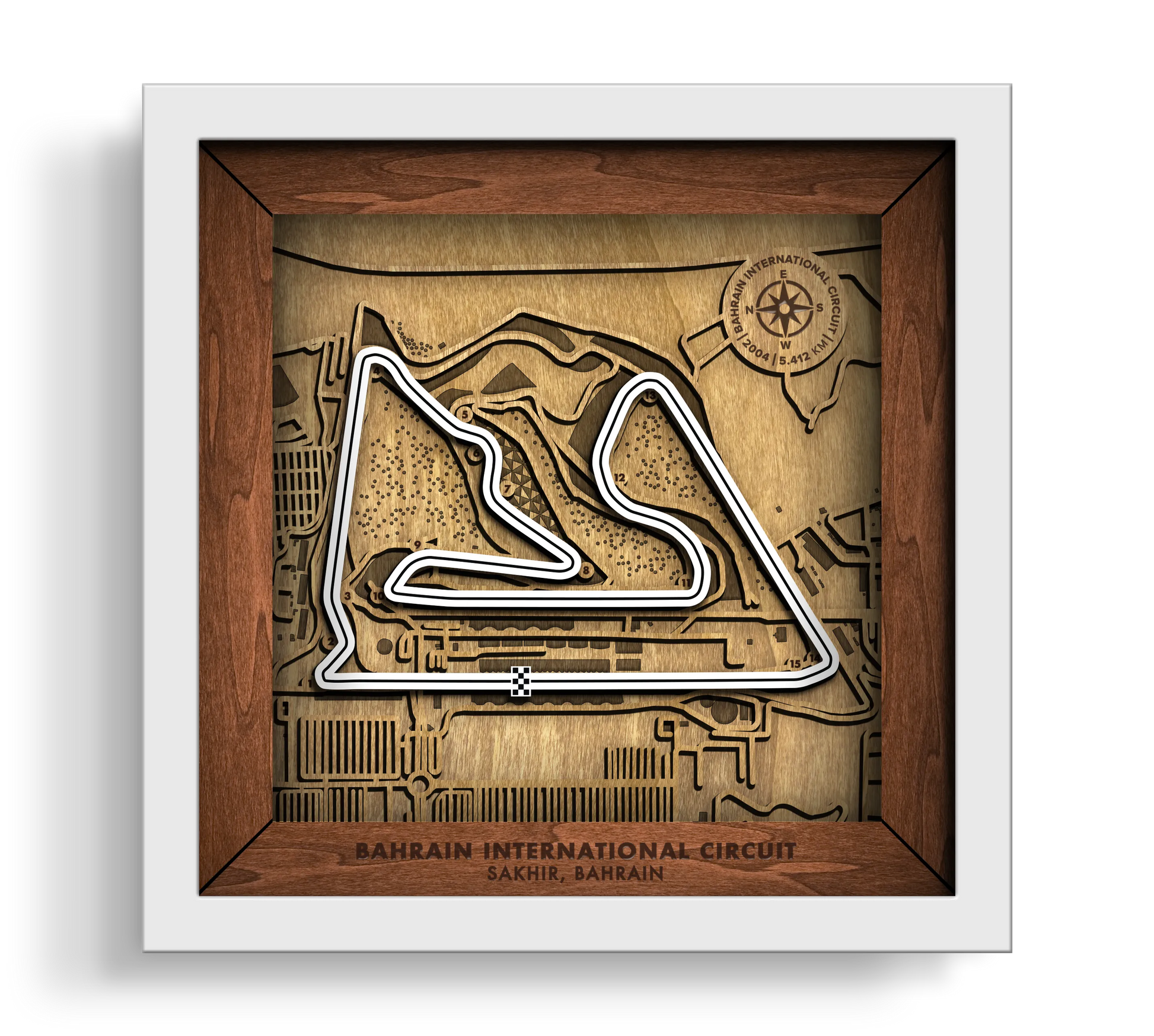 Handcrafted Bahrain International Circuit layered wooden racetrack wall art in a white frame.