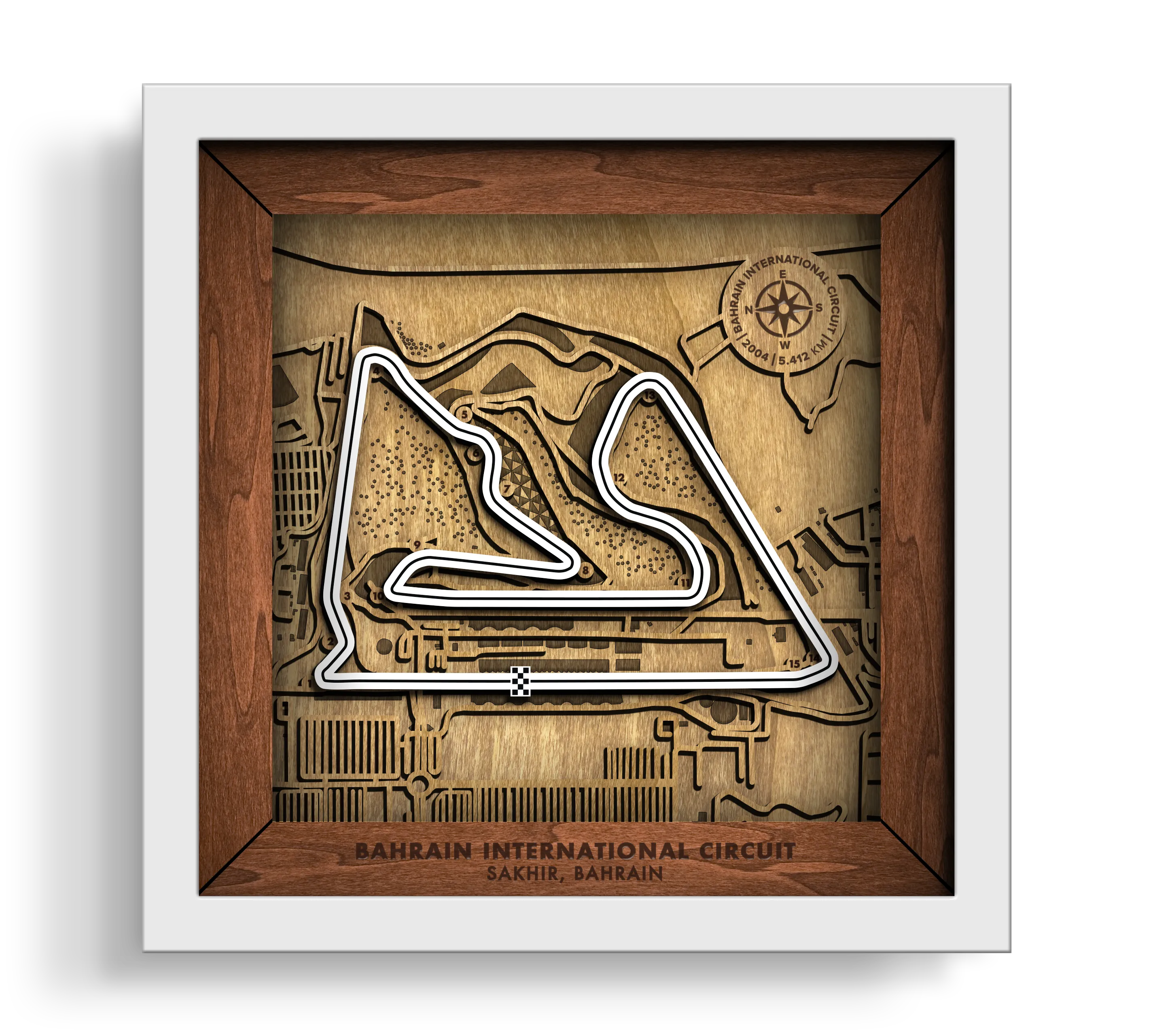 Handcrafted Bahrain International Circuit layered wooden racetrack wall art in a white frame.