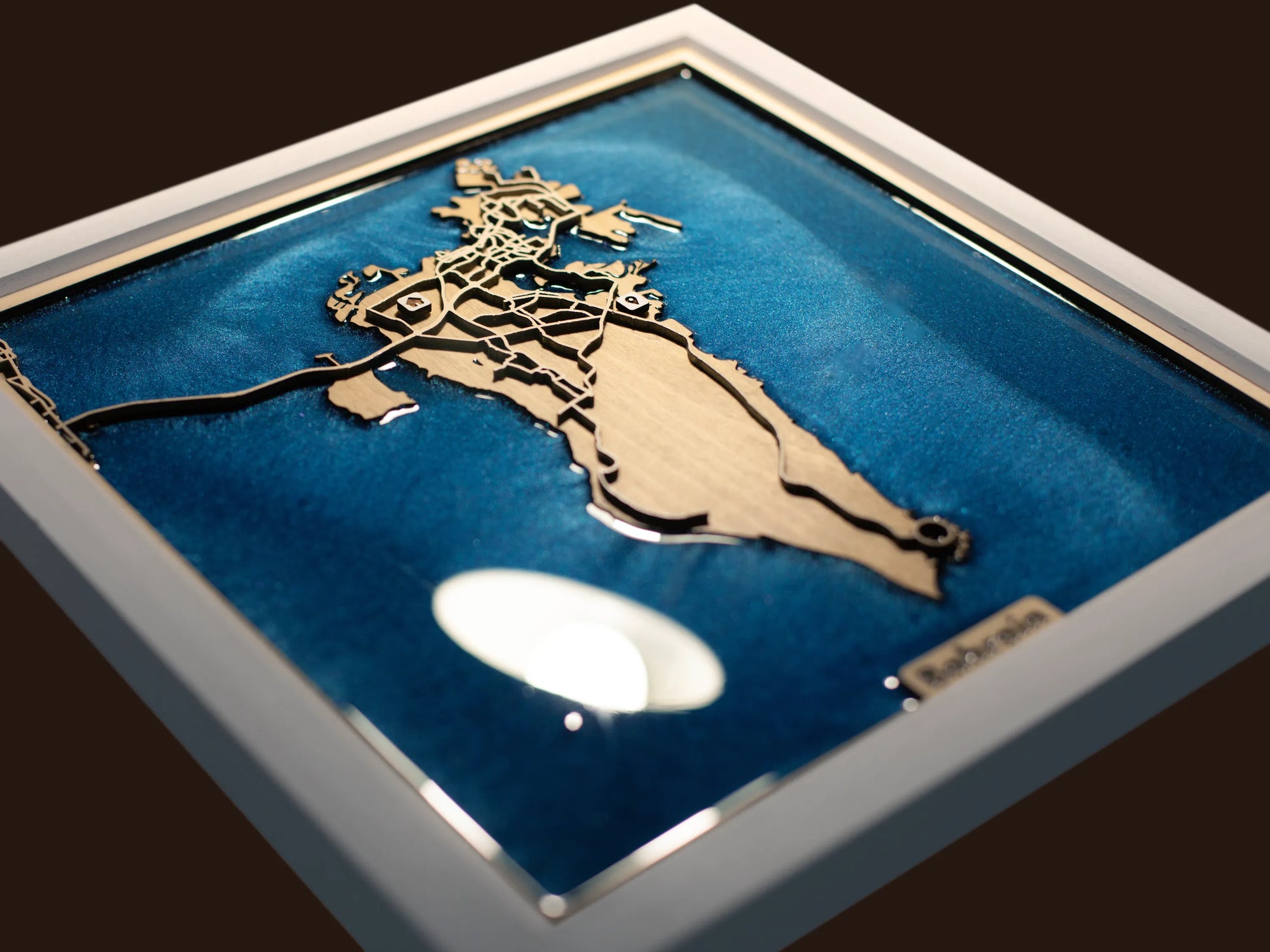 Close-up of the layered wood construction and precision laser engraving of the Bahrain wall art.
