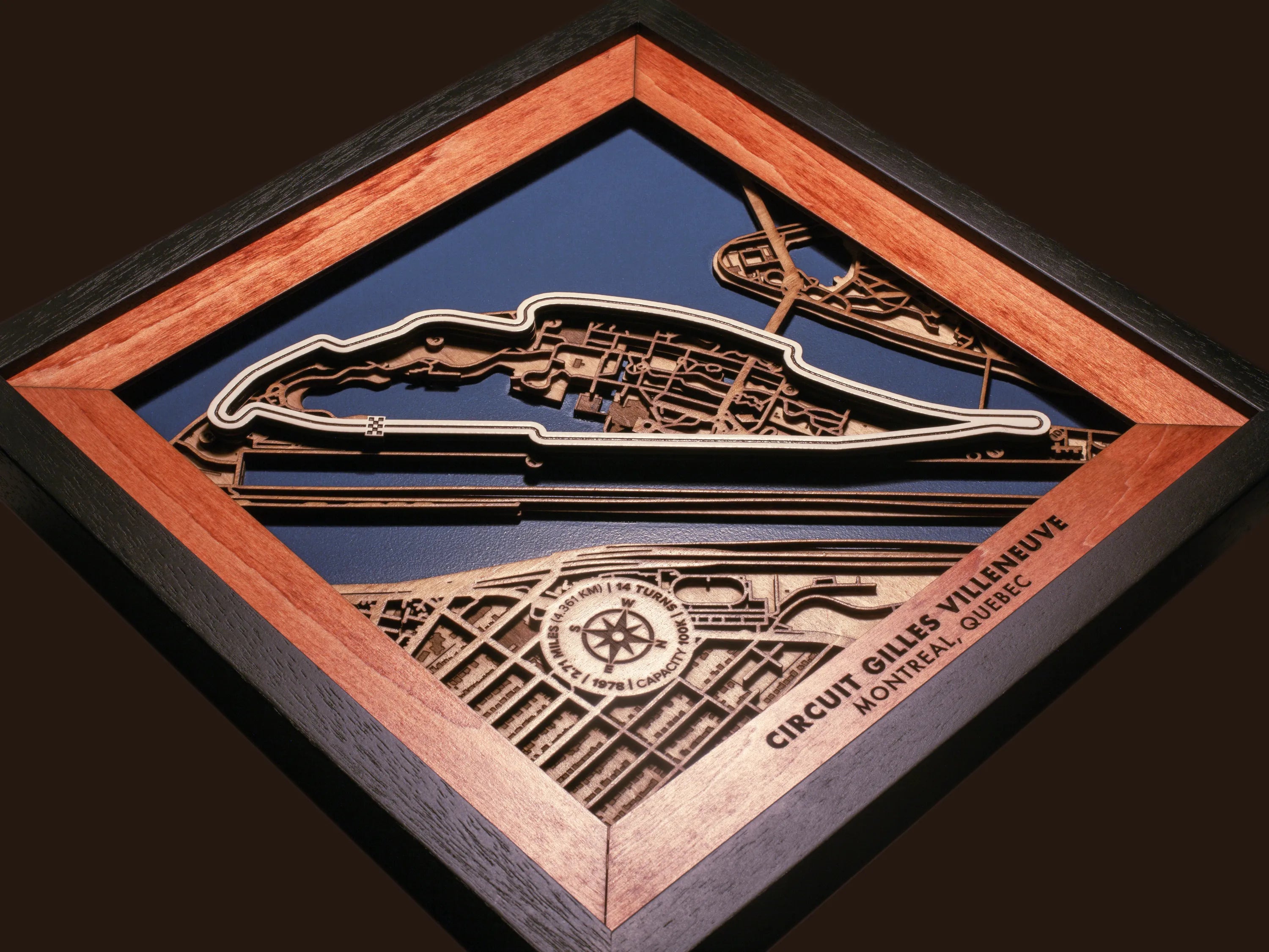 Close-up of the handcrafted layered wood construction and fine details of the Circuit Gilles Villeneuve wall art.