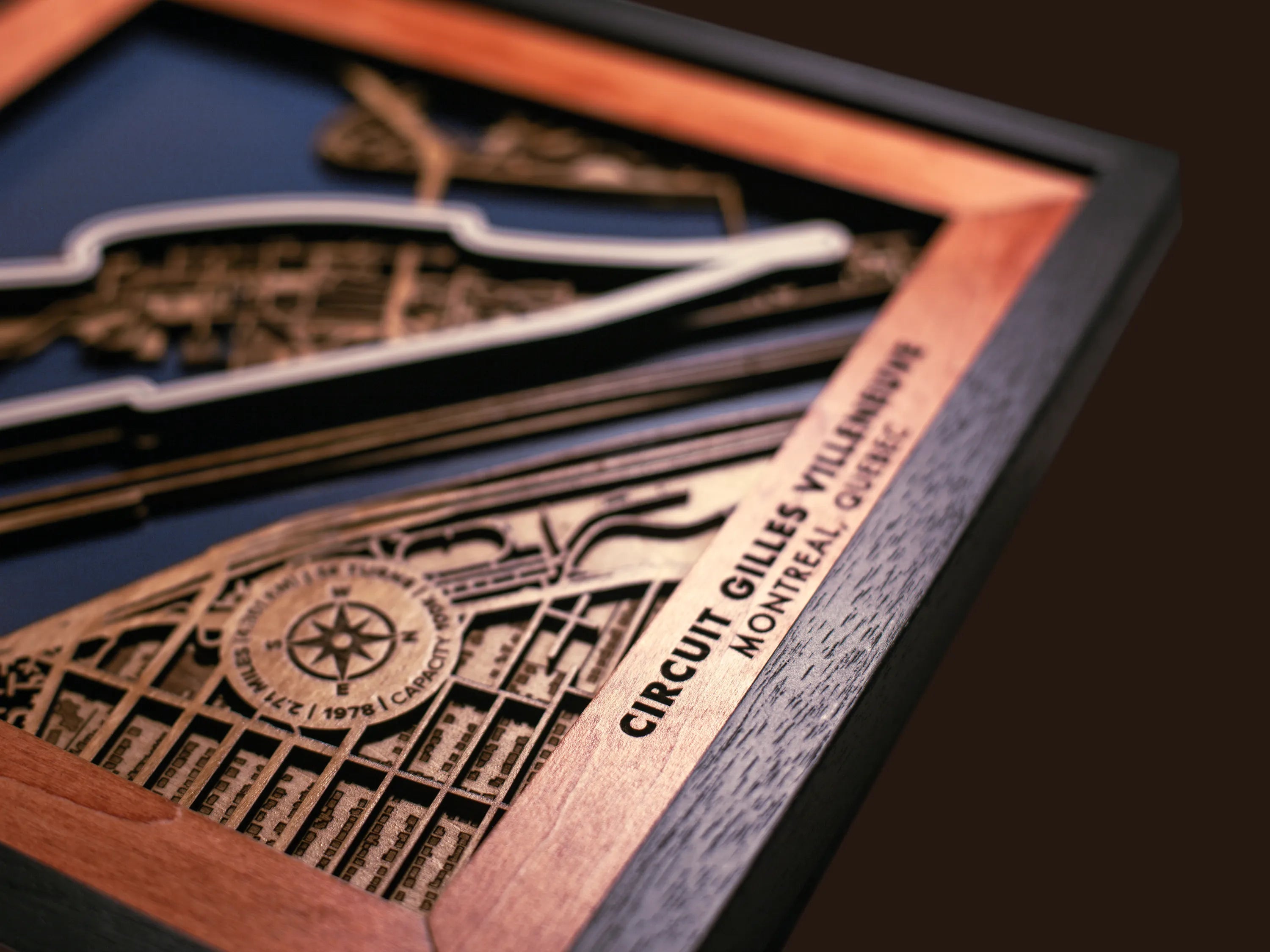 Close-up of the handcrafted layered wood construction and fine details of the Circuit Gilles Villeneuve wall art.