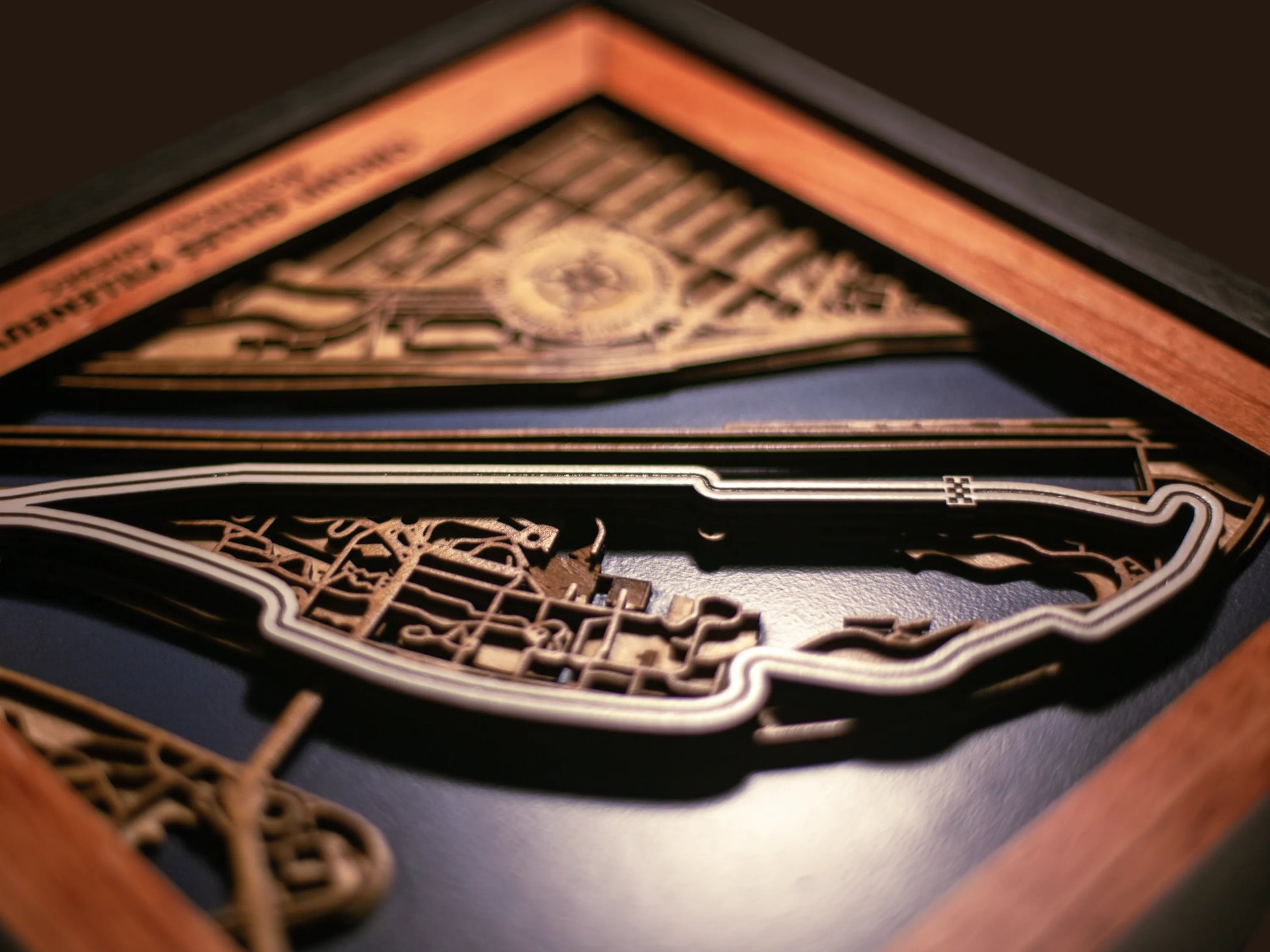 Close-up of the handcrafted layered wood construction and fine details of the Circuit Gilles Villeneuve wall art.