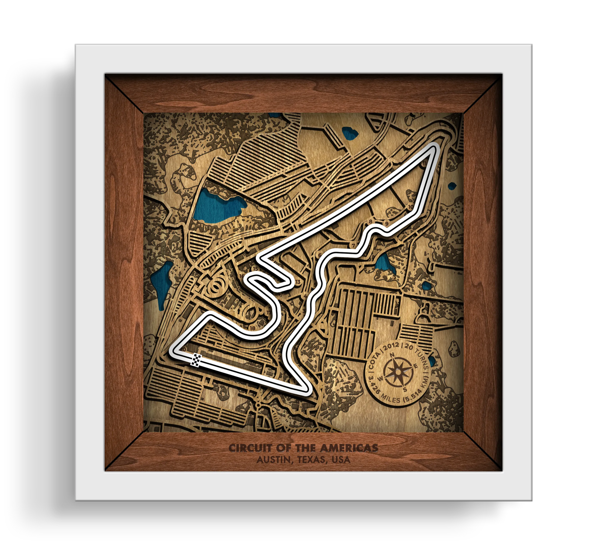 Handcrafted Circuit of The Americas¨ layered wooden racetrack wall art in a white frame.