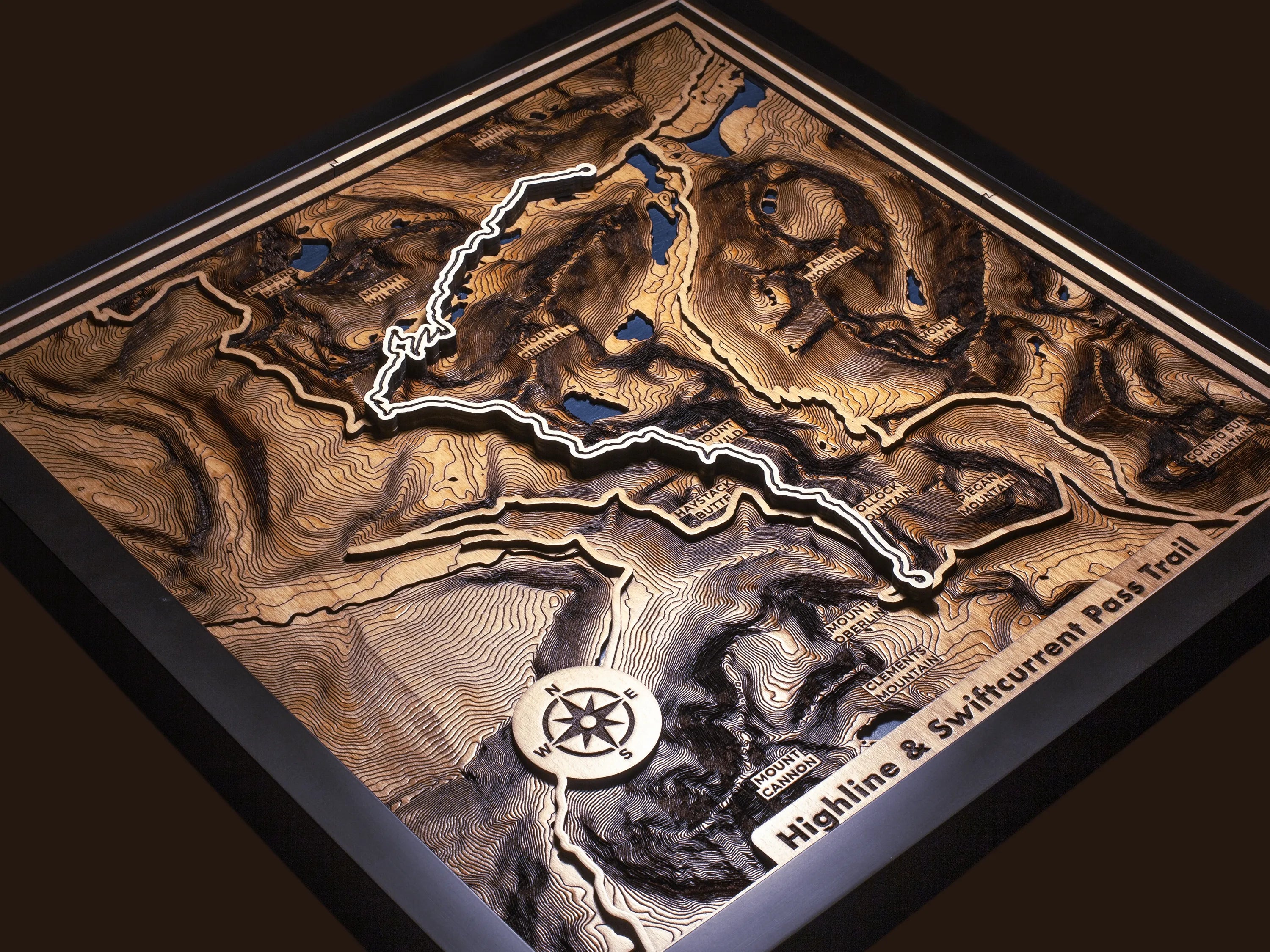 Close-up of the layered wood construction and precision laser engraving of Custom Hiking Trail Maps wall art.