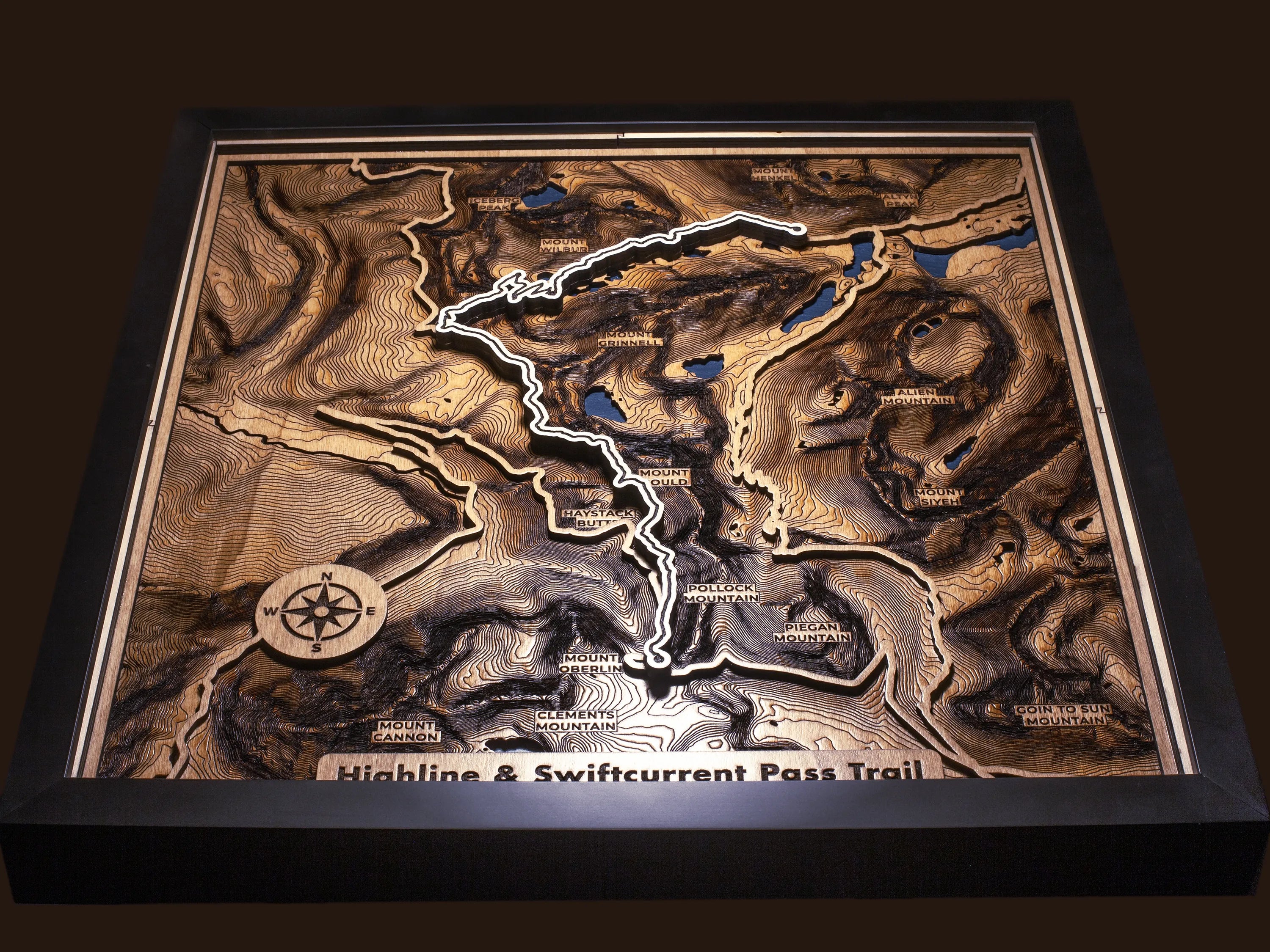 Close-up of the layered wood construction and precision laser engraving of Custom Hiking Trail Maps wall art.