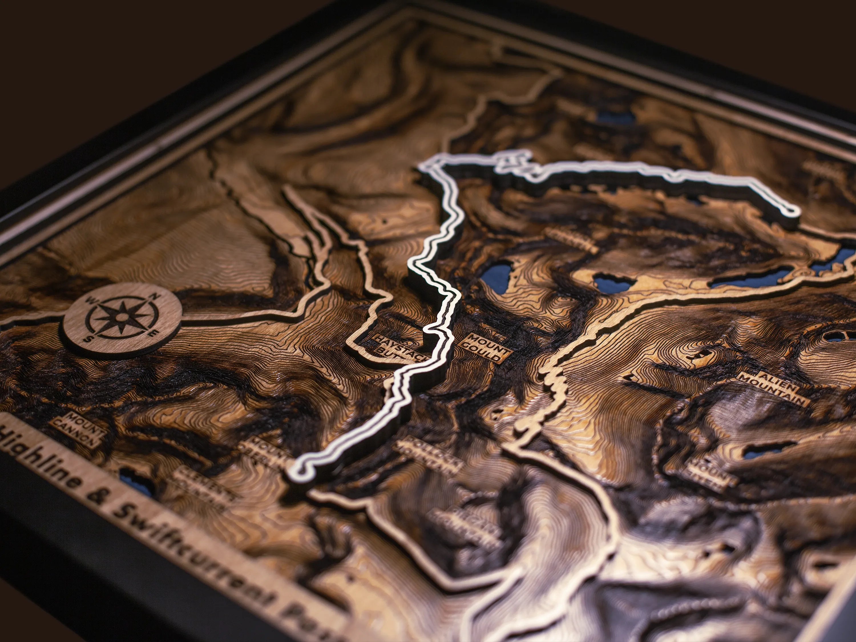Close-up of the layered wood construction and precision laser engraving of Custom Hiking Trail Maps wall art.