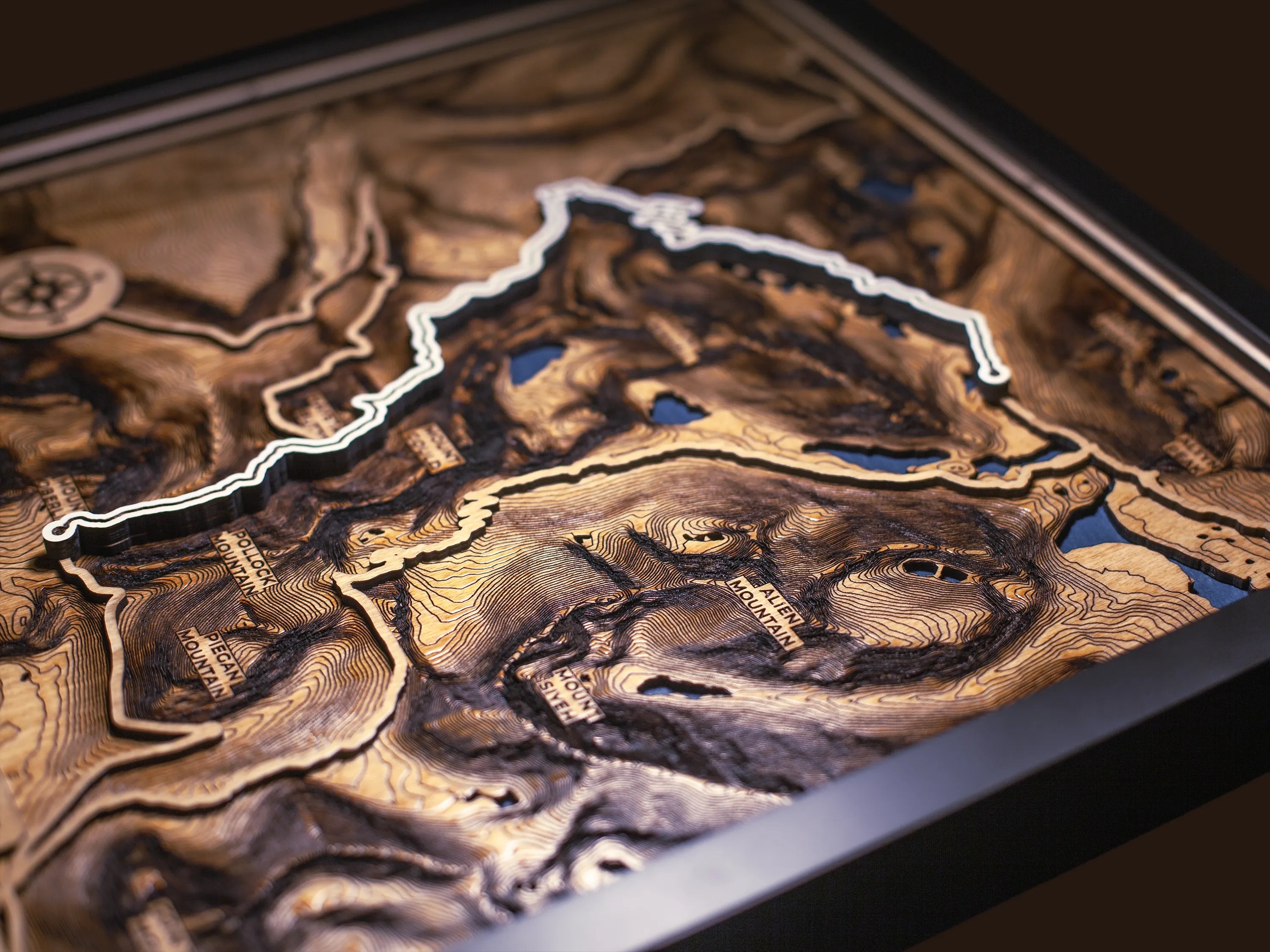 Close-up of the layered wood construction and precision laser engraving of Custom Hiking Trail Maps wall art.