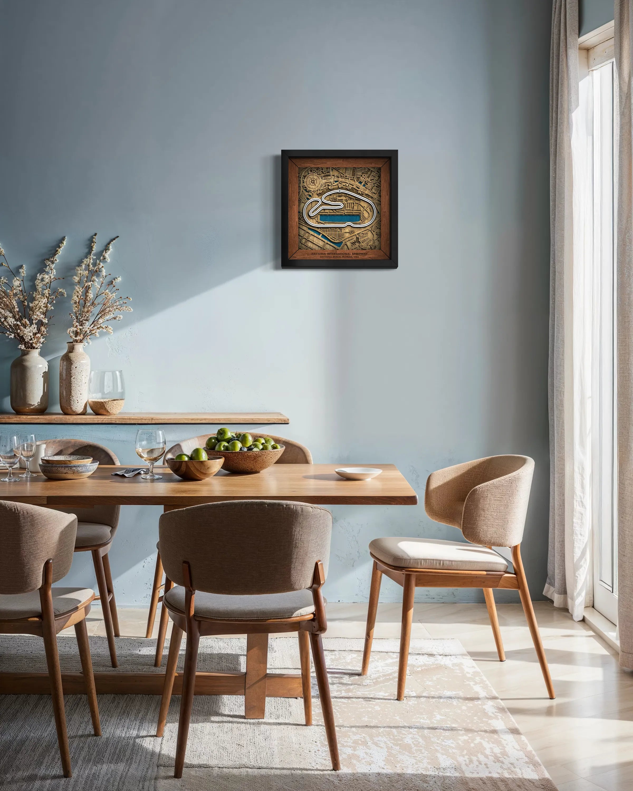 Handcrafted Daytona International Speedway layered wooden racetrack wall art displayed in a modern living room.