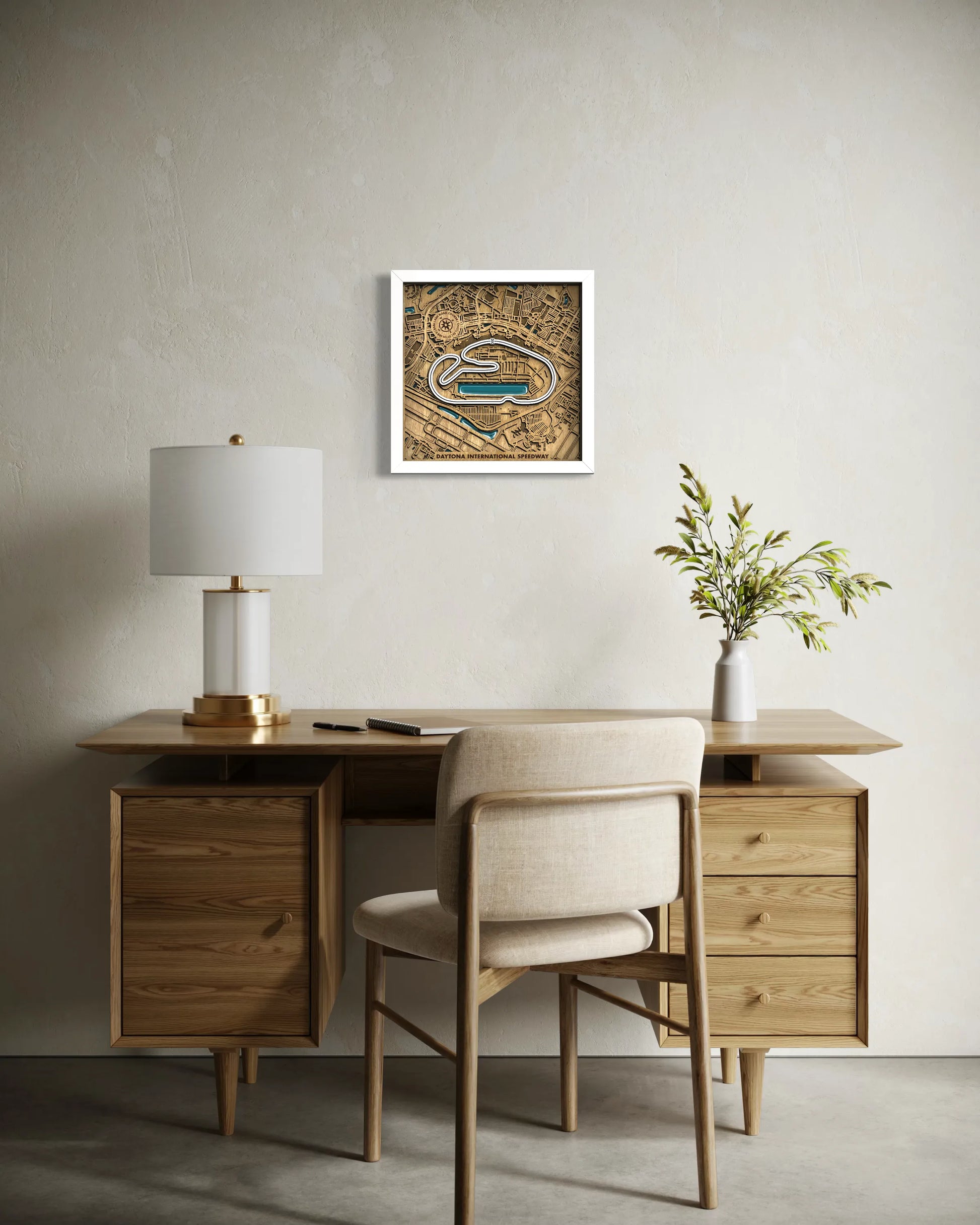 Handcrafted Daytona International Speedway layered wooden racetrack wall art with epoxy resin waters displayed in a modern living room.