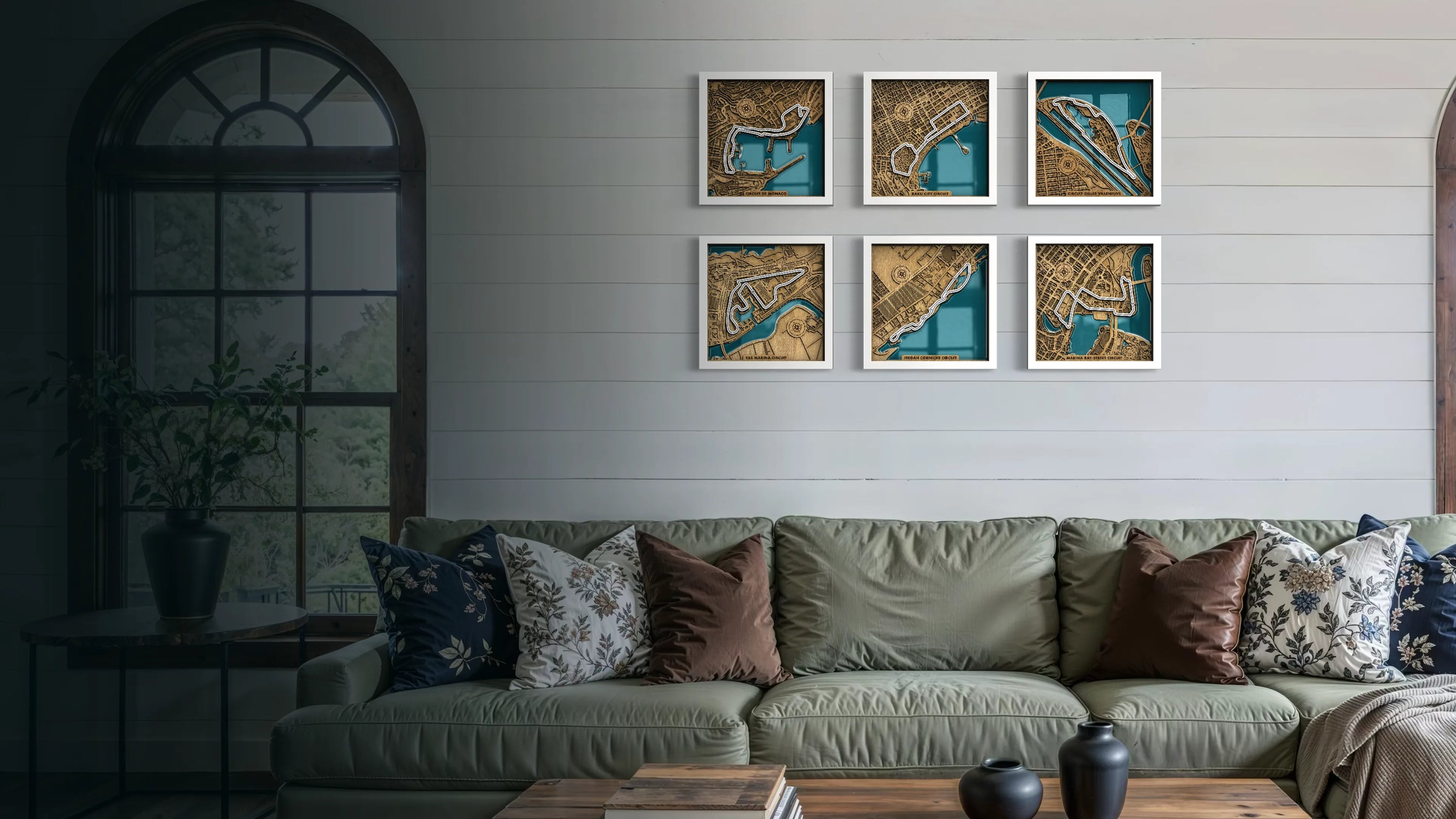 Living room with a green sofa, decorative pillows, and framed artwork on the wall.