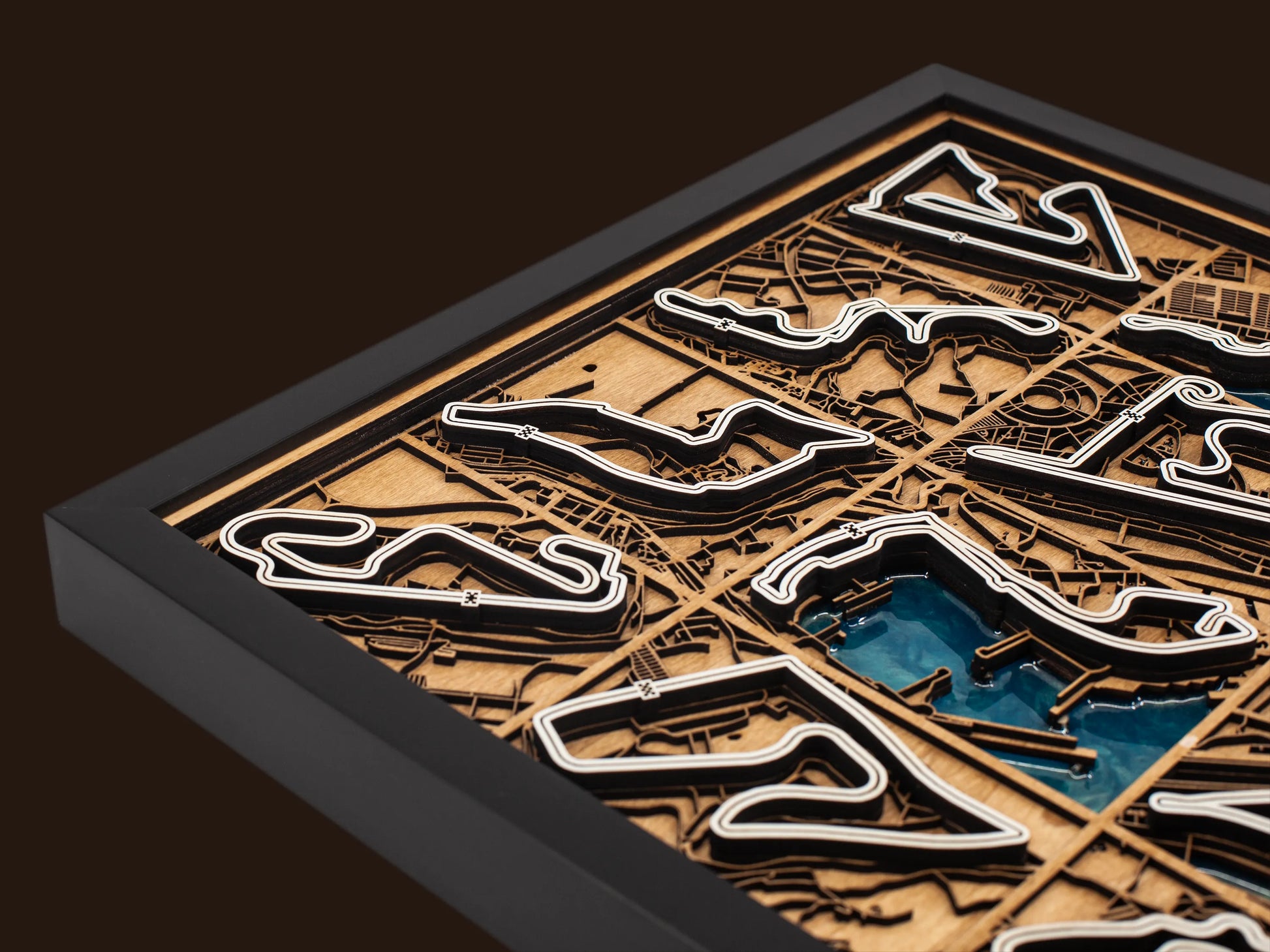 Close-up of the handcrafted layered wood construction and epoxy resin details of the F1 World Collection wall art.