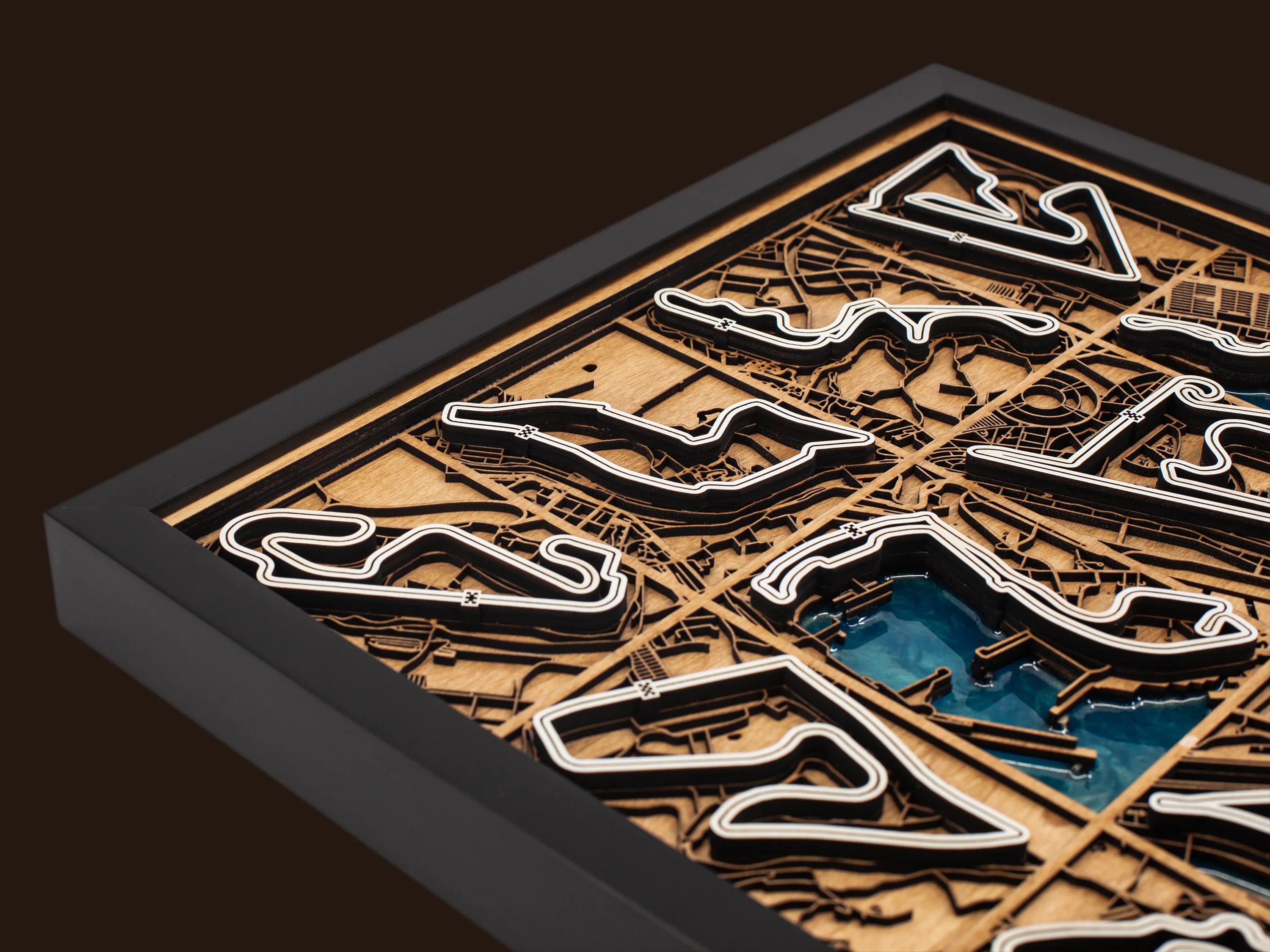 Close-up of the handcrafted layered wood construction and epoxy resin details of the F1 World Collection wall art.
