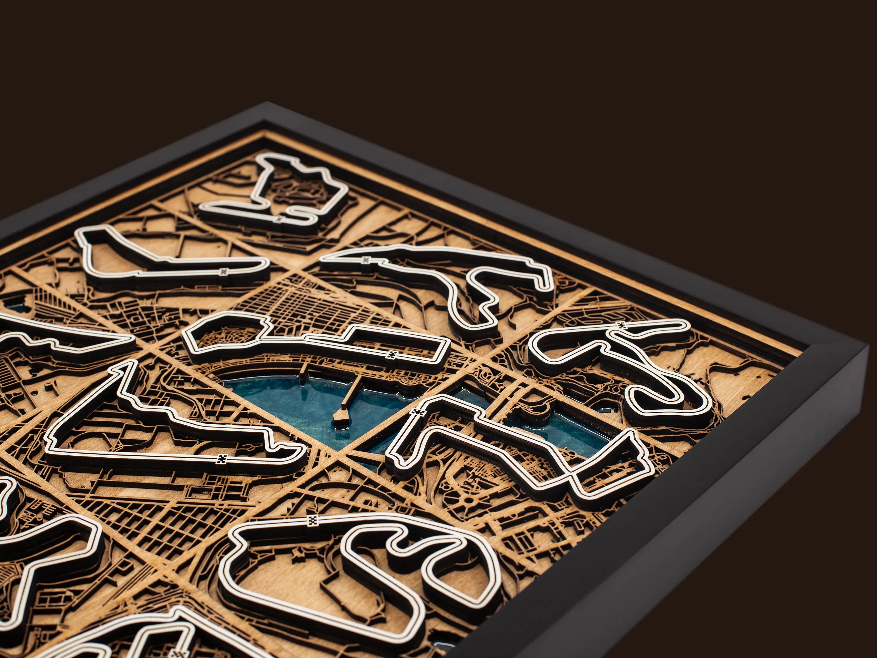 Close-up of the handcrafted layered wood construction and epoxy resin details of the F1 World Collection wall art.