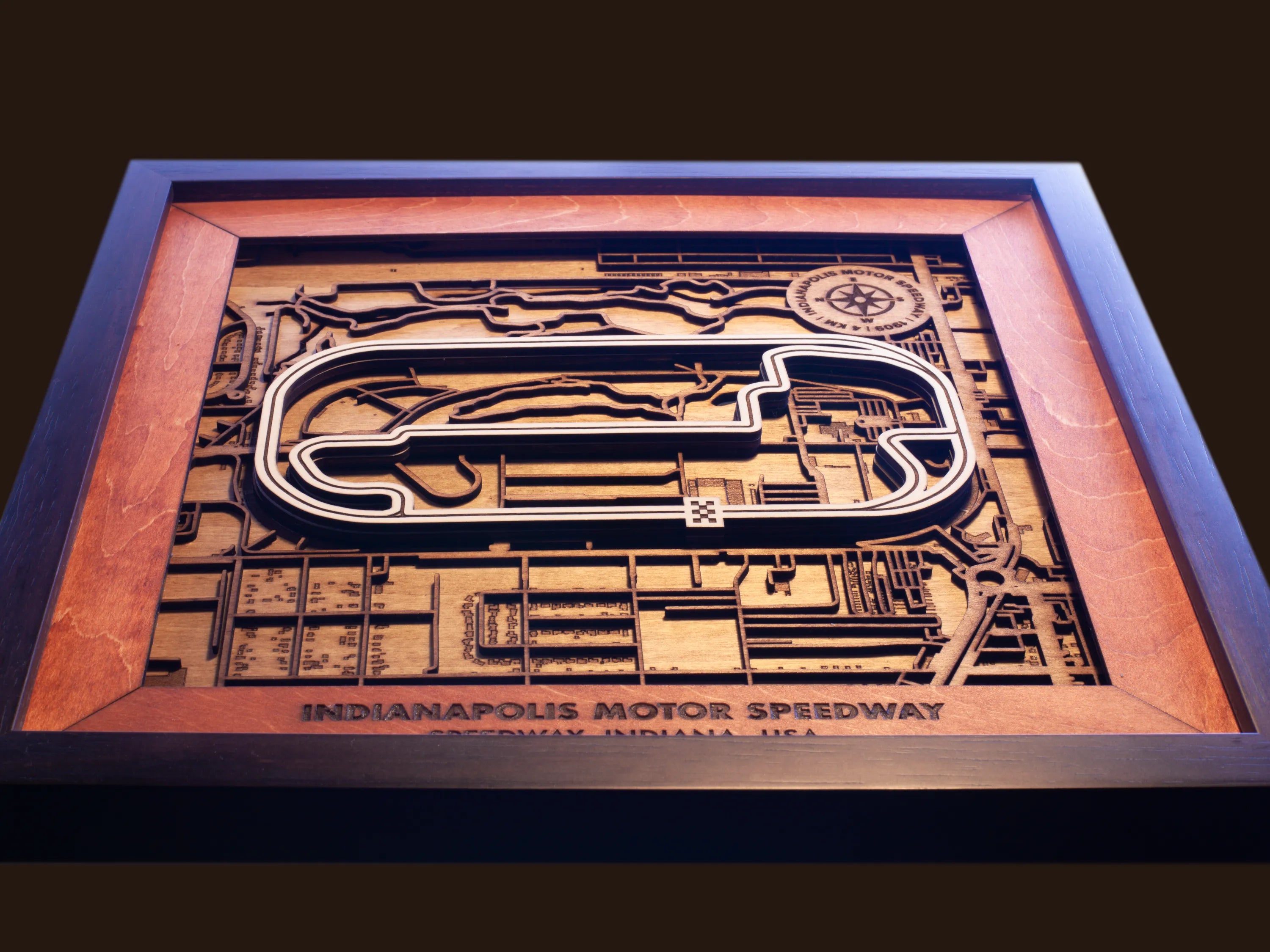 Close-up of the handcrafted layered wood construction and fine details of the Indianapolis Motor Speedway wall art.
