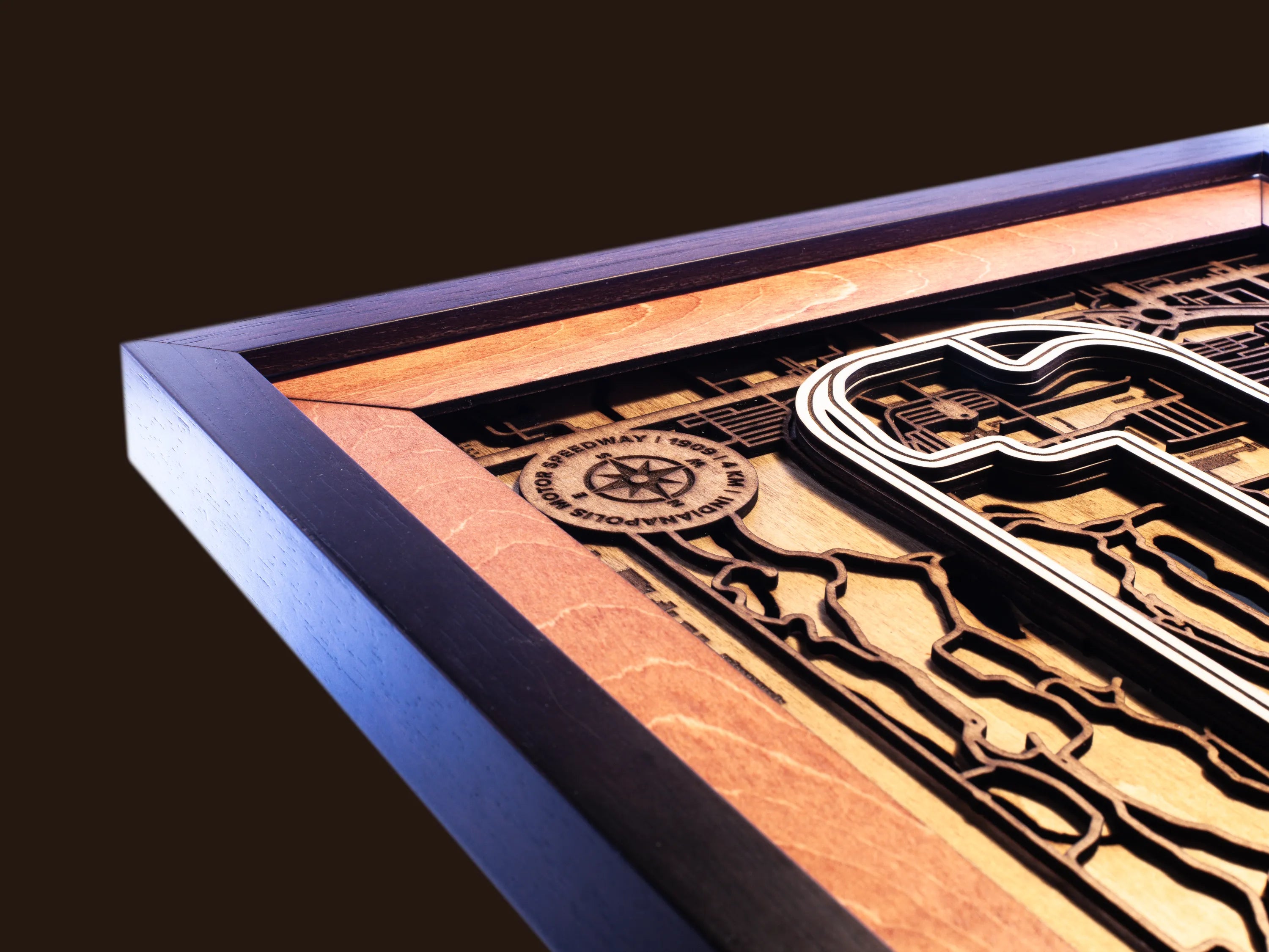 Close-up of the handcrafted layered wood construction and fine details of the Indianapolis Motor Speedway wall art.