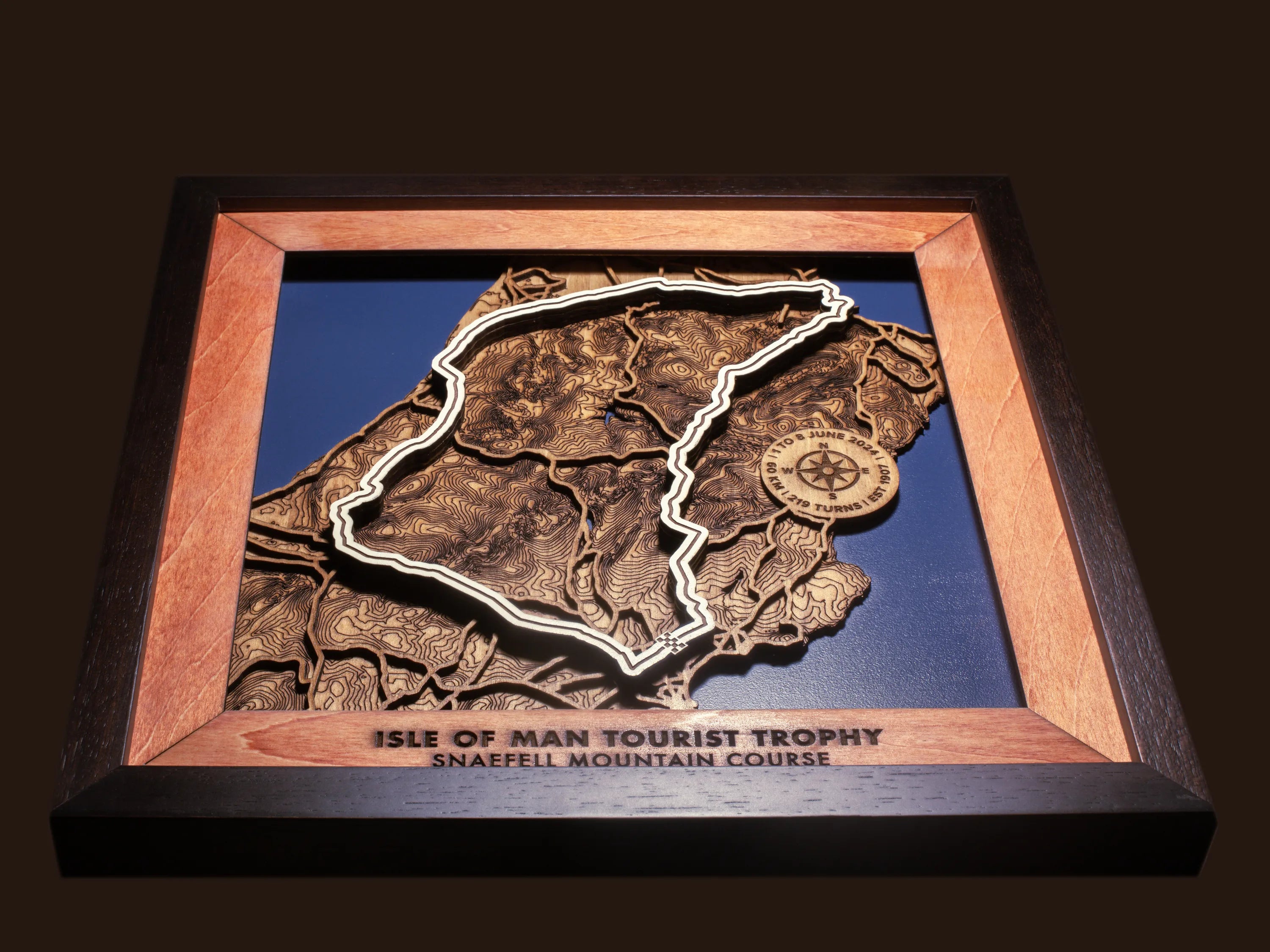 Close-up of the handcrafted layered wood construction and fine details of the Isle of Man TT Course wall art.