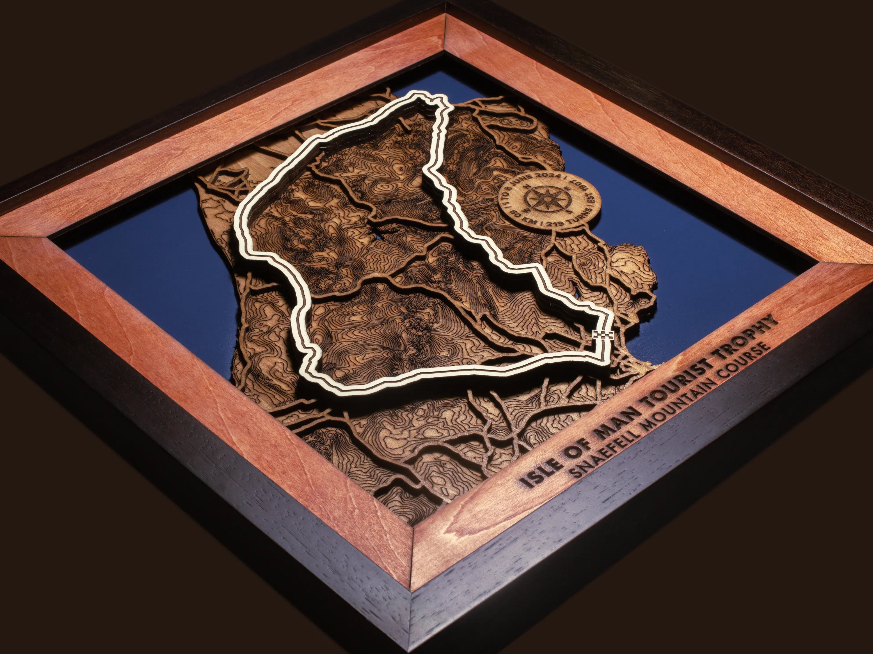 Close-up of the handcrafted layered wood construction and fine details of the Isle of Man TT Course wall art.