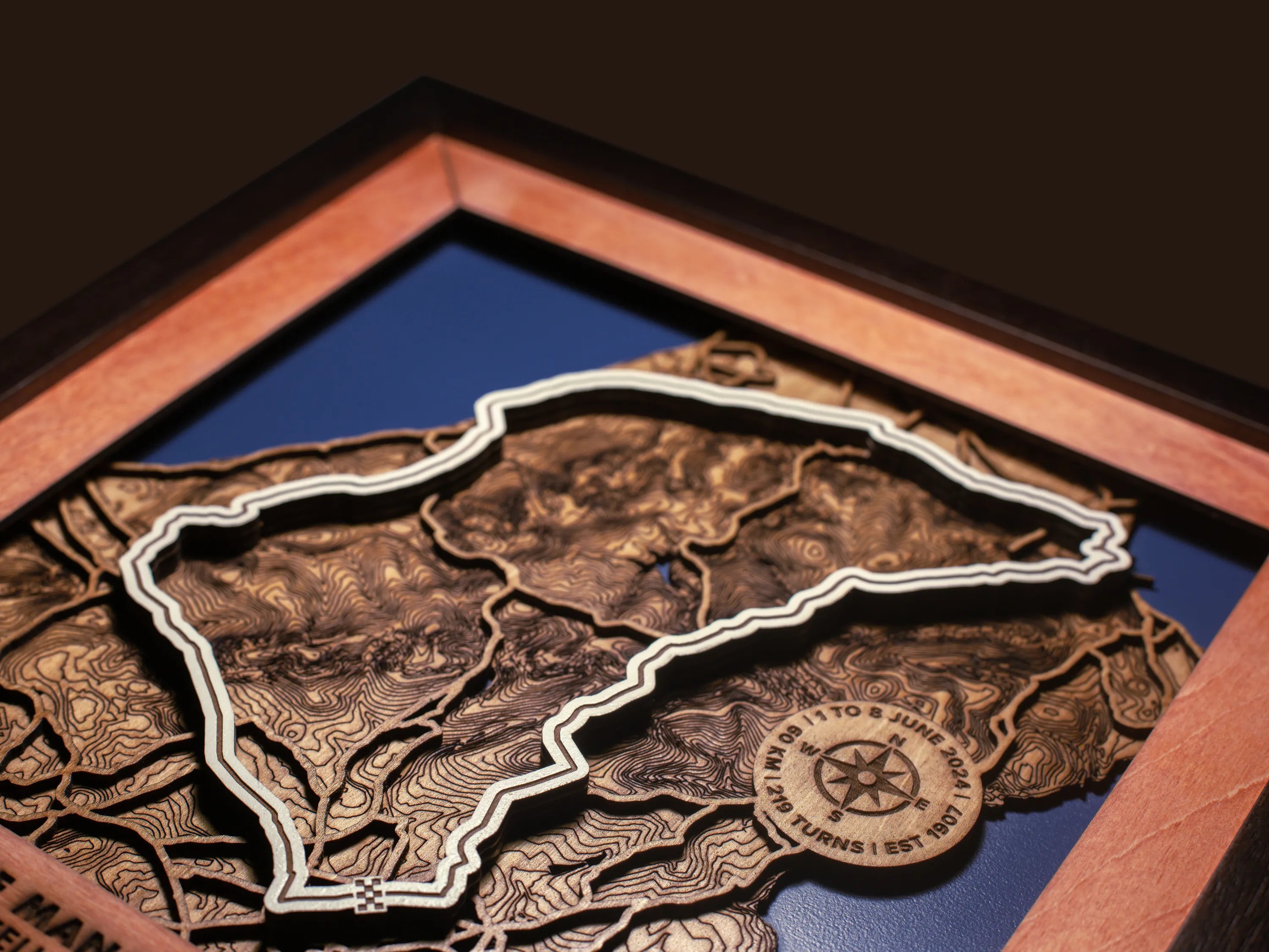 Close-up of the handcrafted layered wood construction and fine details of the Isle of Man TT Course wall art.