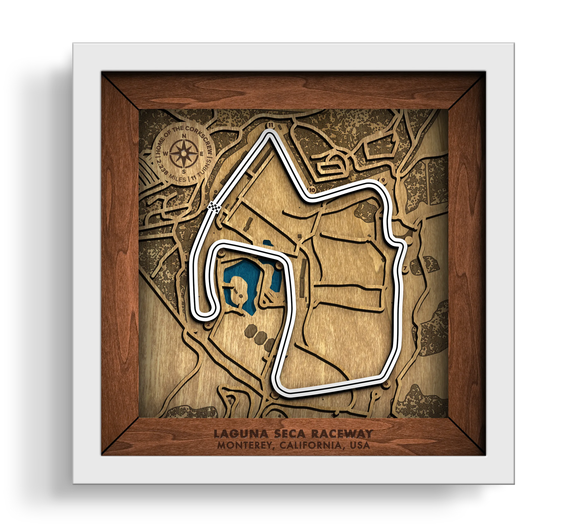 Handcrafted WeatherTech Raceway Laguna Seca layered wooden racetrack wall art in a white frame.