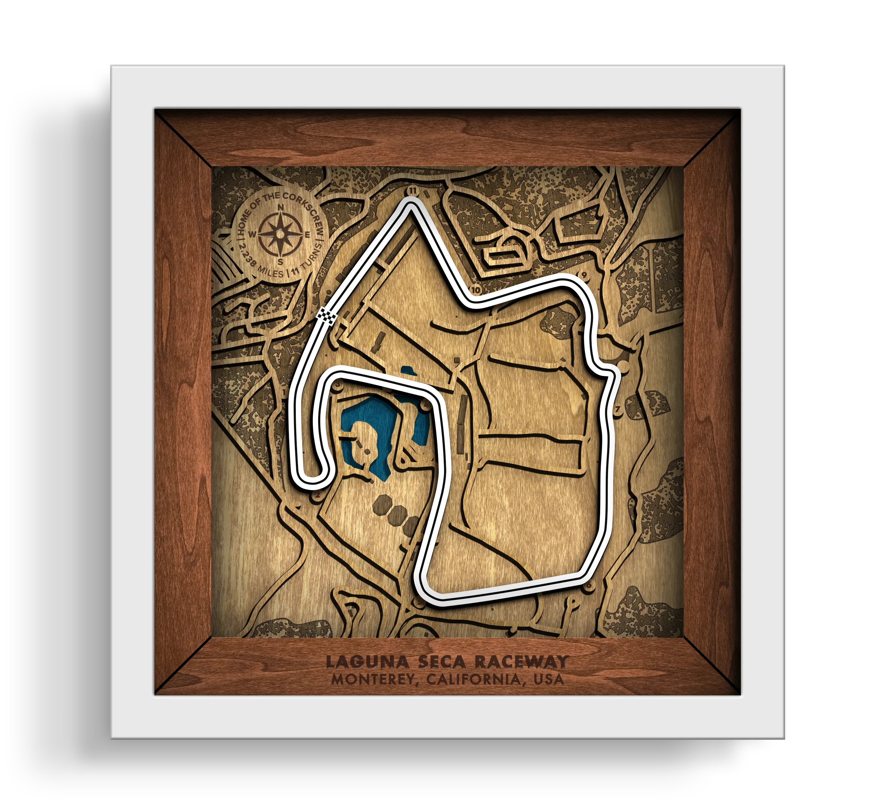 Handcrafted WeatherTech Raceway Laguna Seca layered wooden racetrack wall art in a white frame.