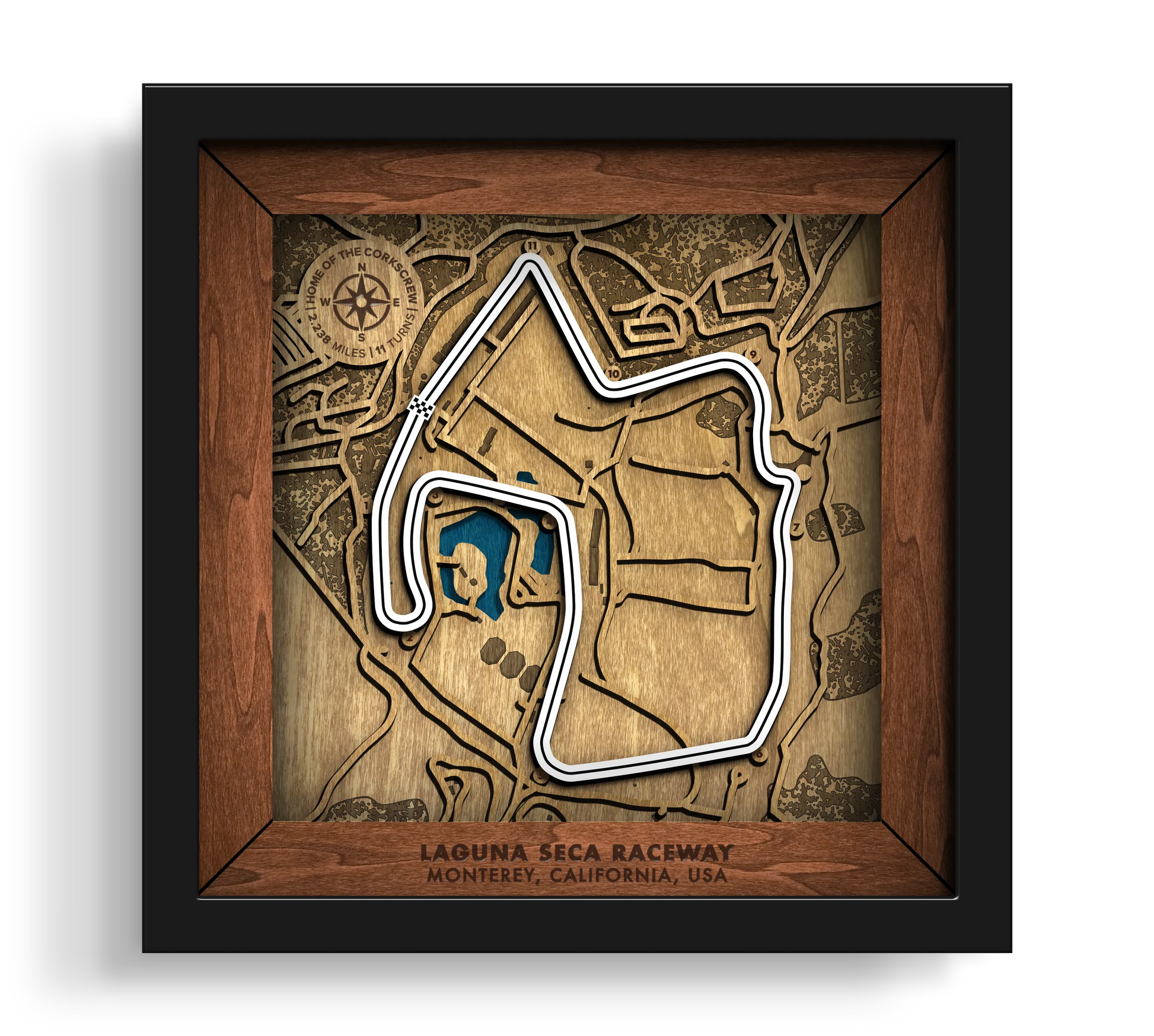 Handcrafted WeatherTech Raceway Laguna Seca layered wooden racetrack wall art in a black frame.