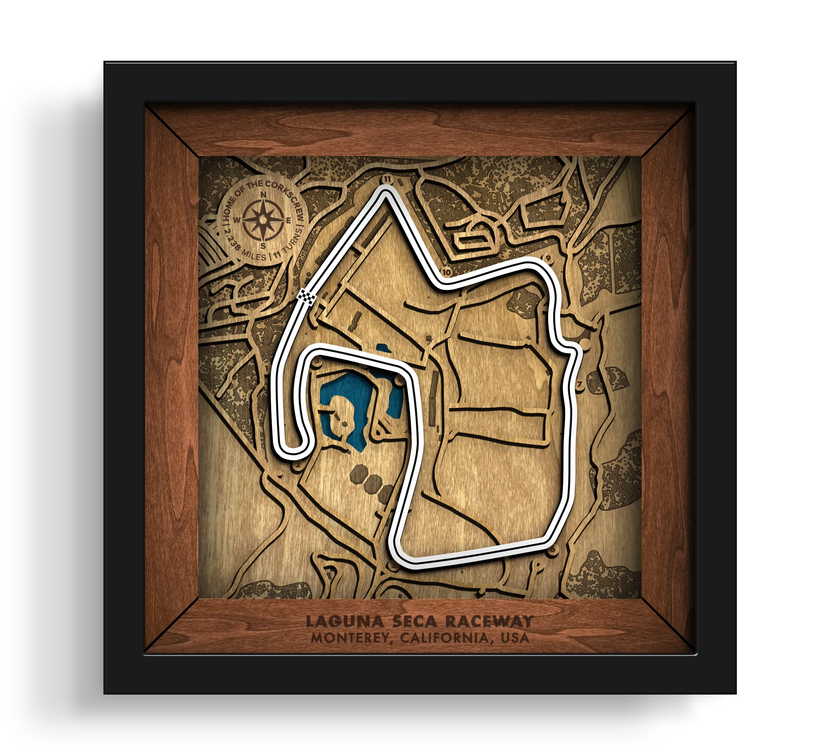 Handcrafted WeatherTech Raceway Laguna Seca layered wooden racetrack wall art in a black frame.