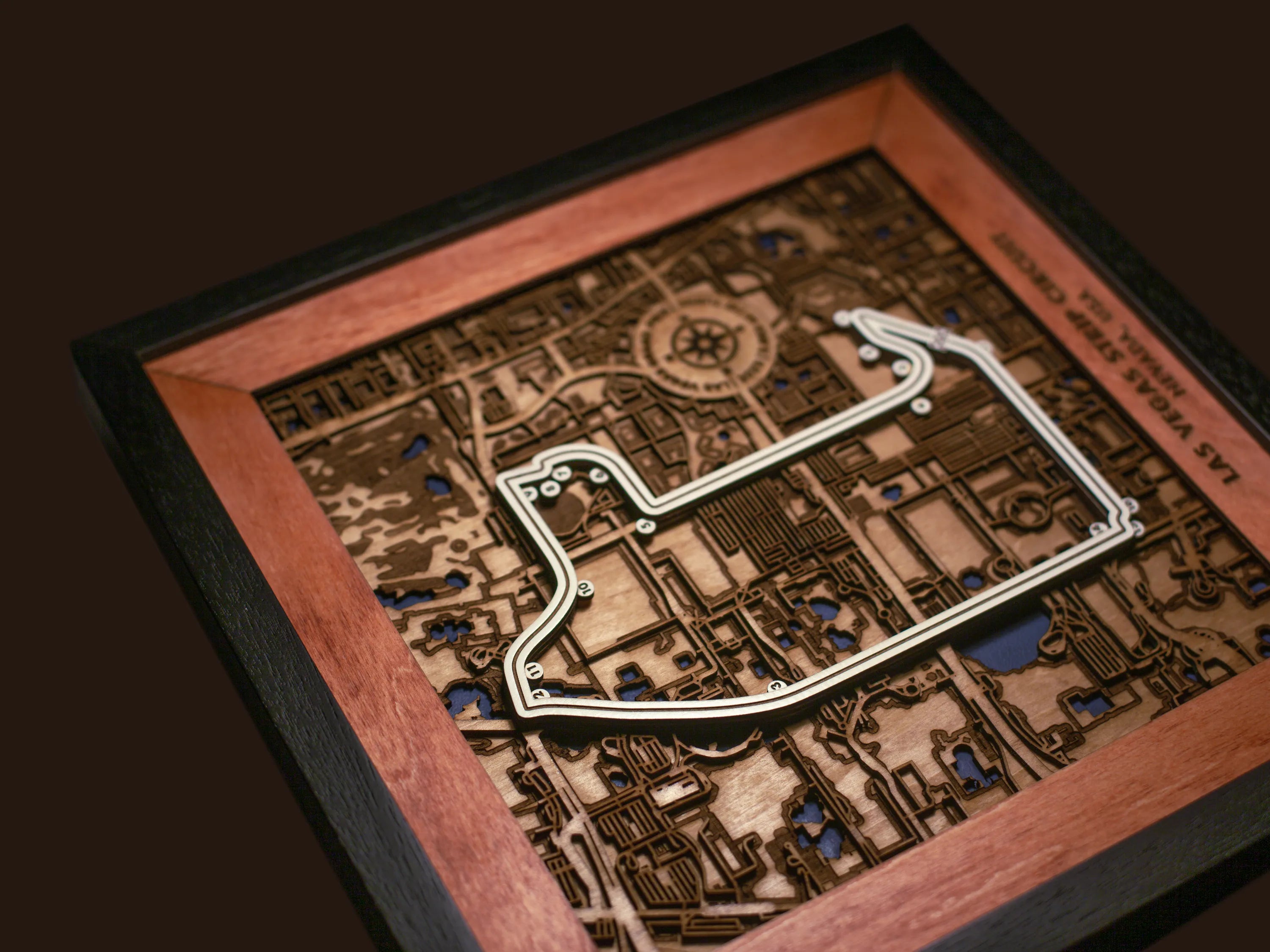 Close-up of the handcrafted layered wood construction and fine details of the Las Vegas Strip Circuit wall art.