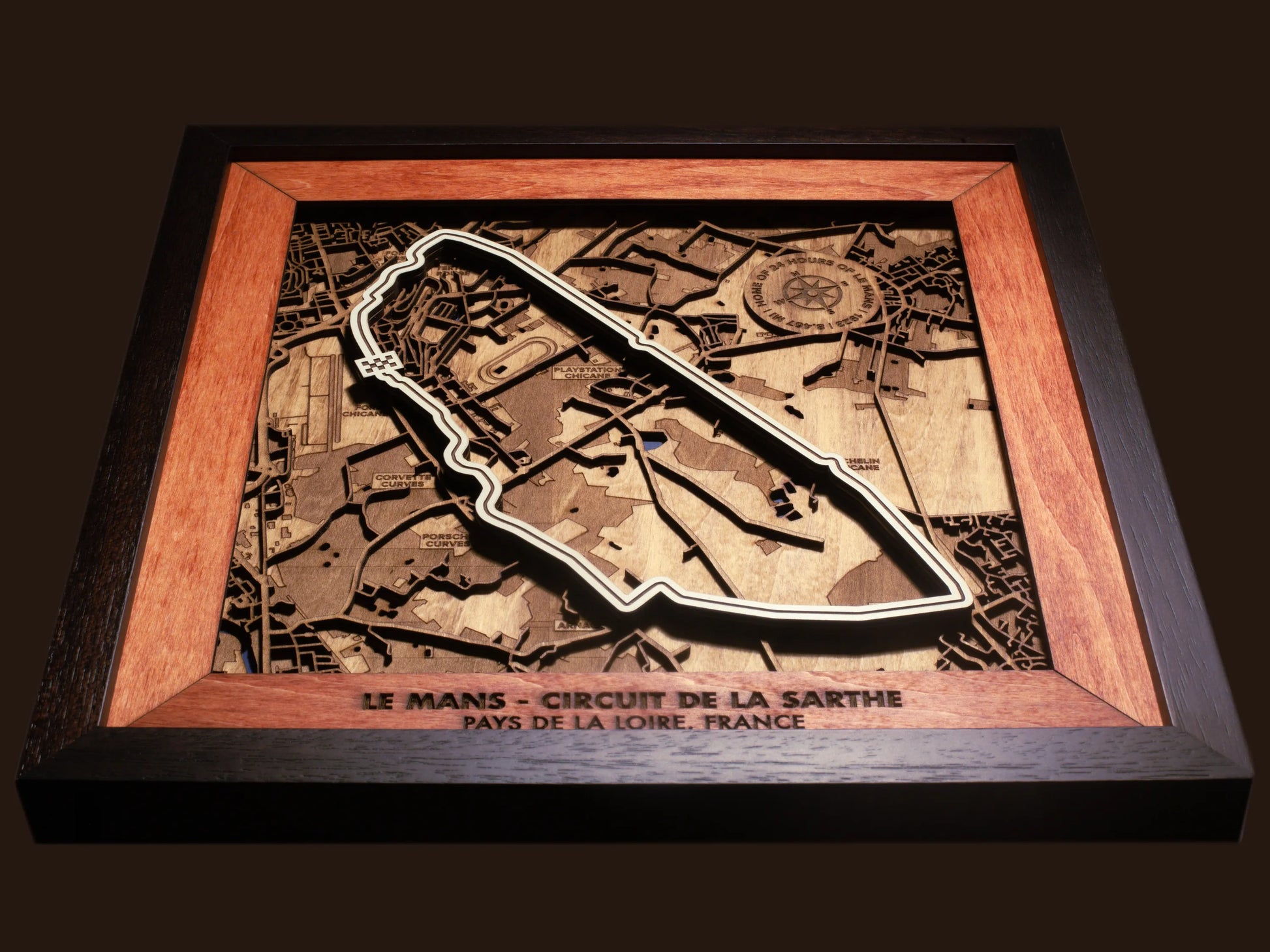 Close-up of the handcrafted layered wood construction and fine details of the Le Mans Circuit wall art.