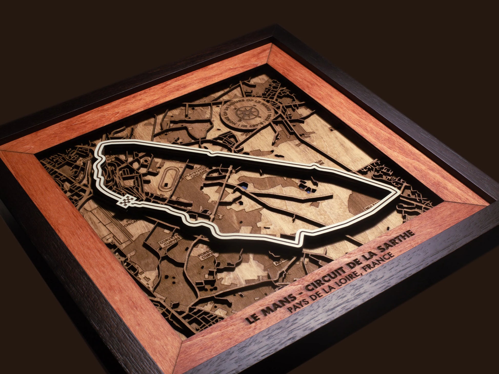 Close-up of the handcrafted layered wood construction and fine details of the Le Mans Circuit wall art.