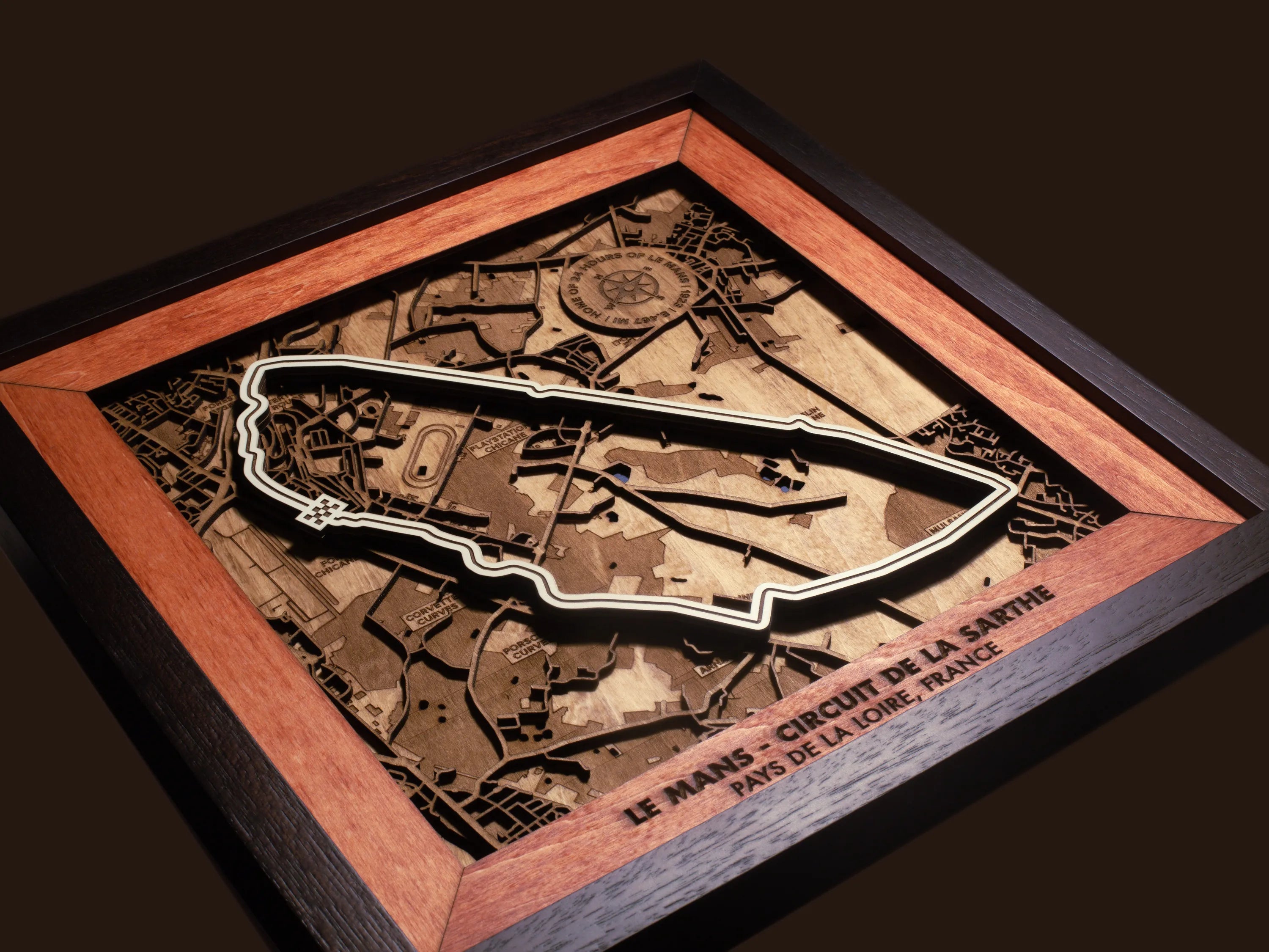 Close-up of the handcrafted layered wood construction and fine details of the Le Mans Circuit wall art.