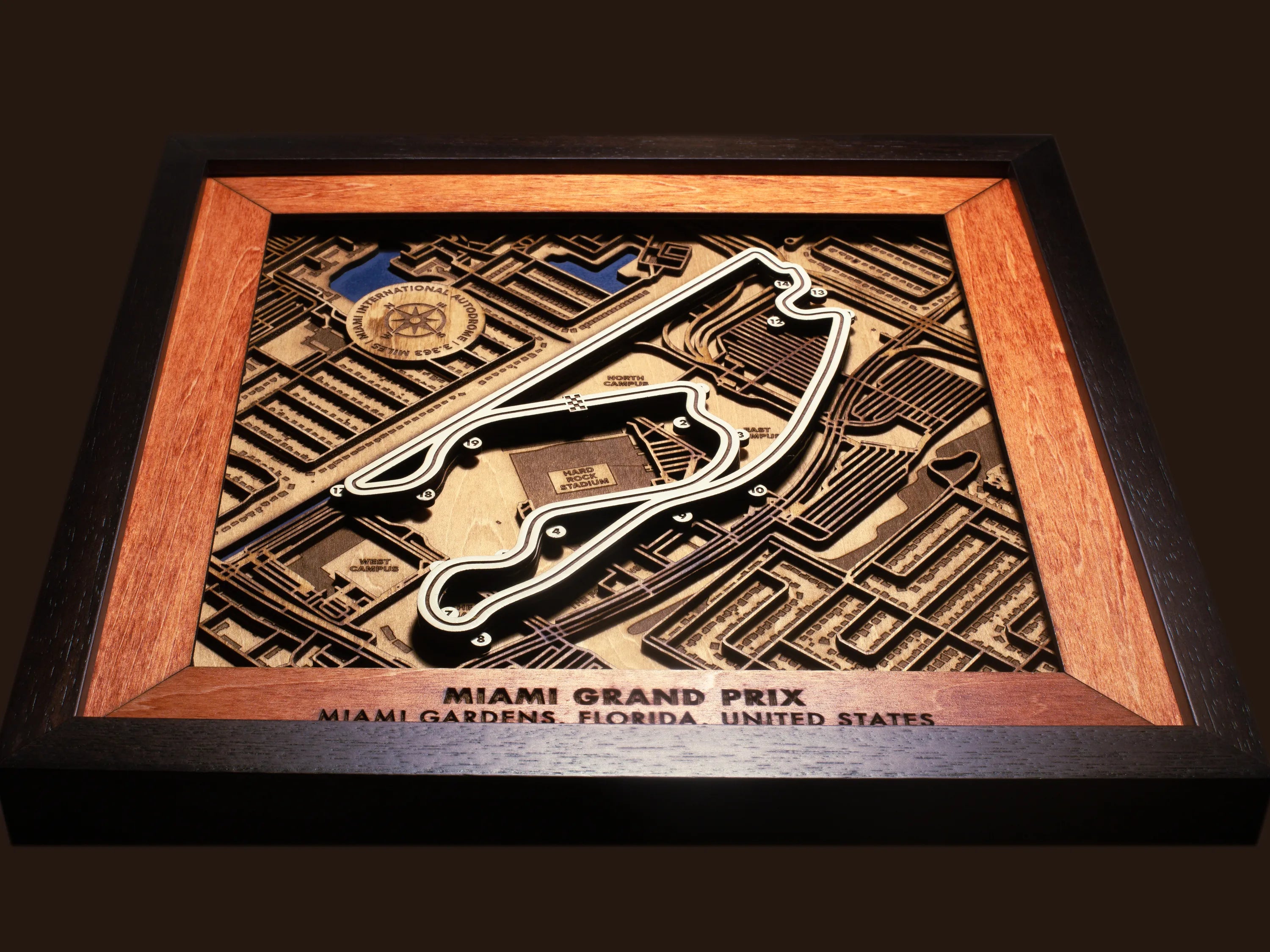 Close-up of the handcrafted layered wood construction and fine details of the Miami International Autodrome wall art.