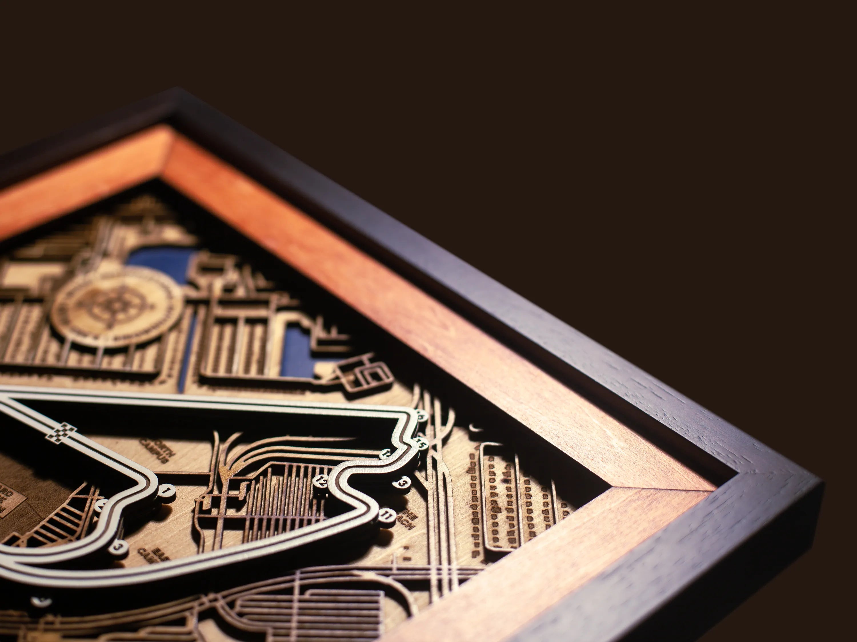 Close-up of the handcrafted layered wood construction and fine details of the Miami International Autodrome wall art.
