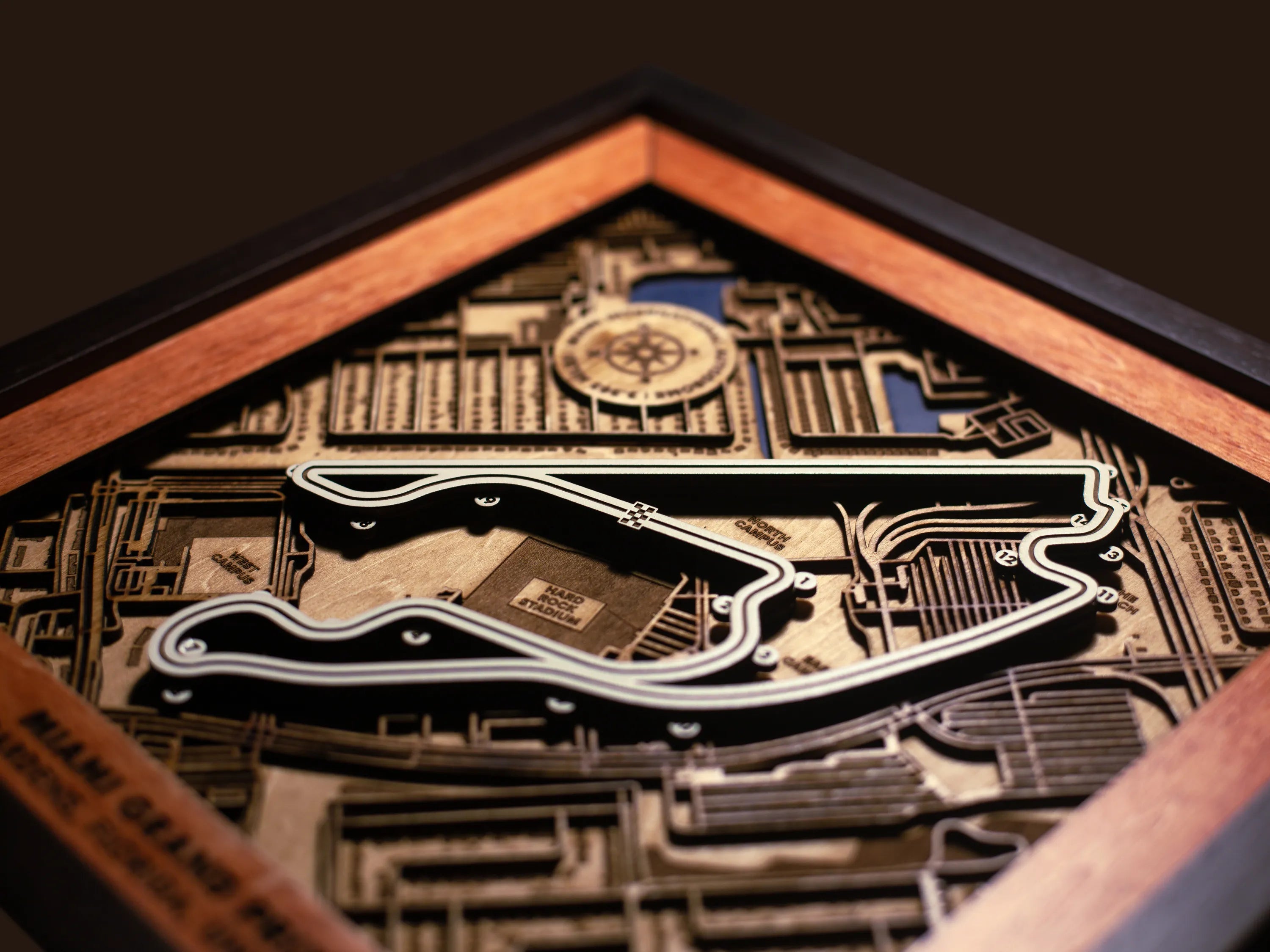 Close-up of the handcrafted layered wood construction and fine details of the Miami International Autodrome wall art.