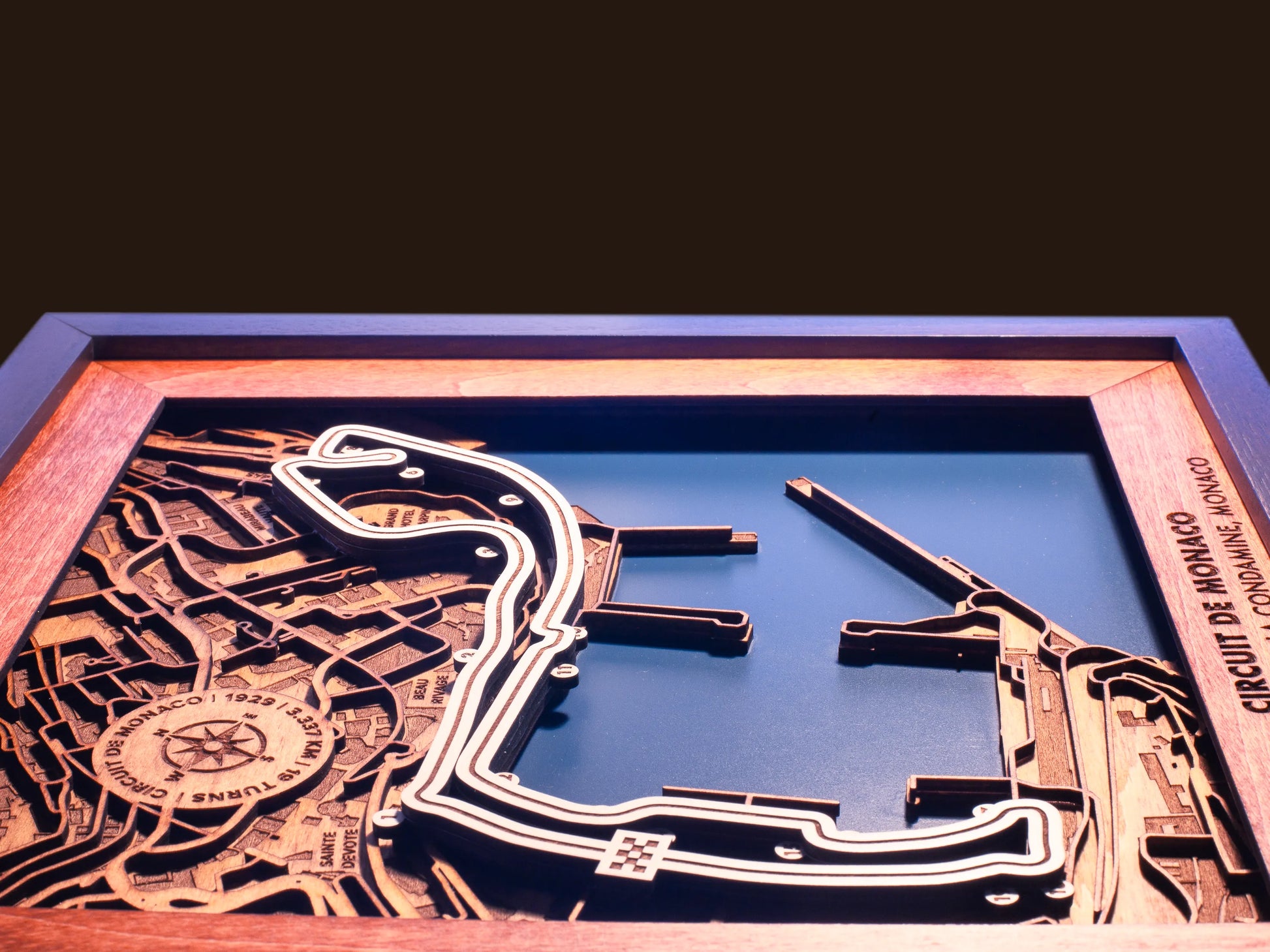 Close-up of the handcrafted layered wood construction and fine details of the Circuit de Monaco wall art.