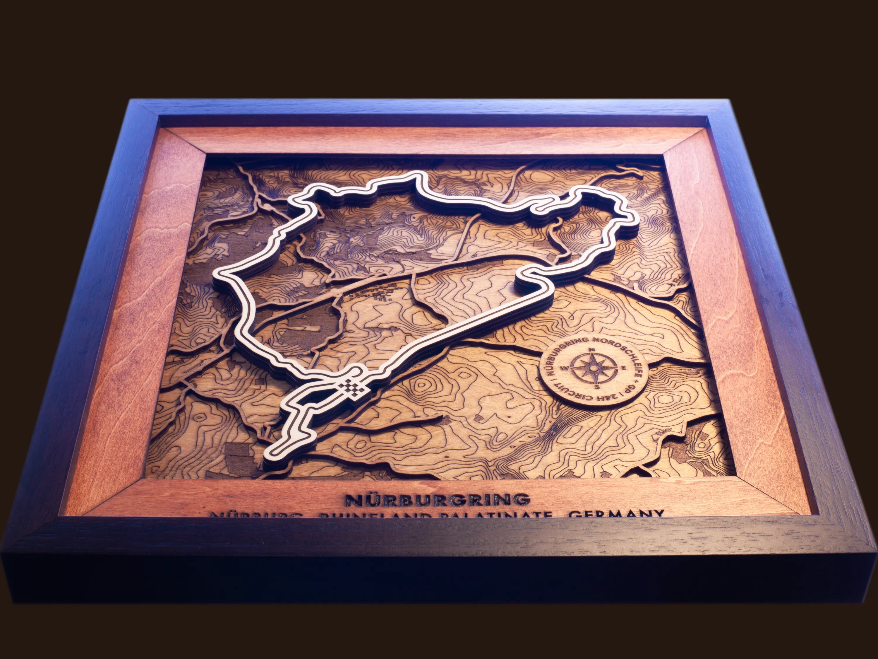 Close-up of the handcrafted layered wood construction and fine details of the NŸrburgring Nordschleife wall art.