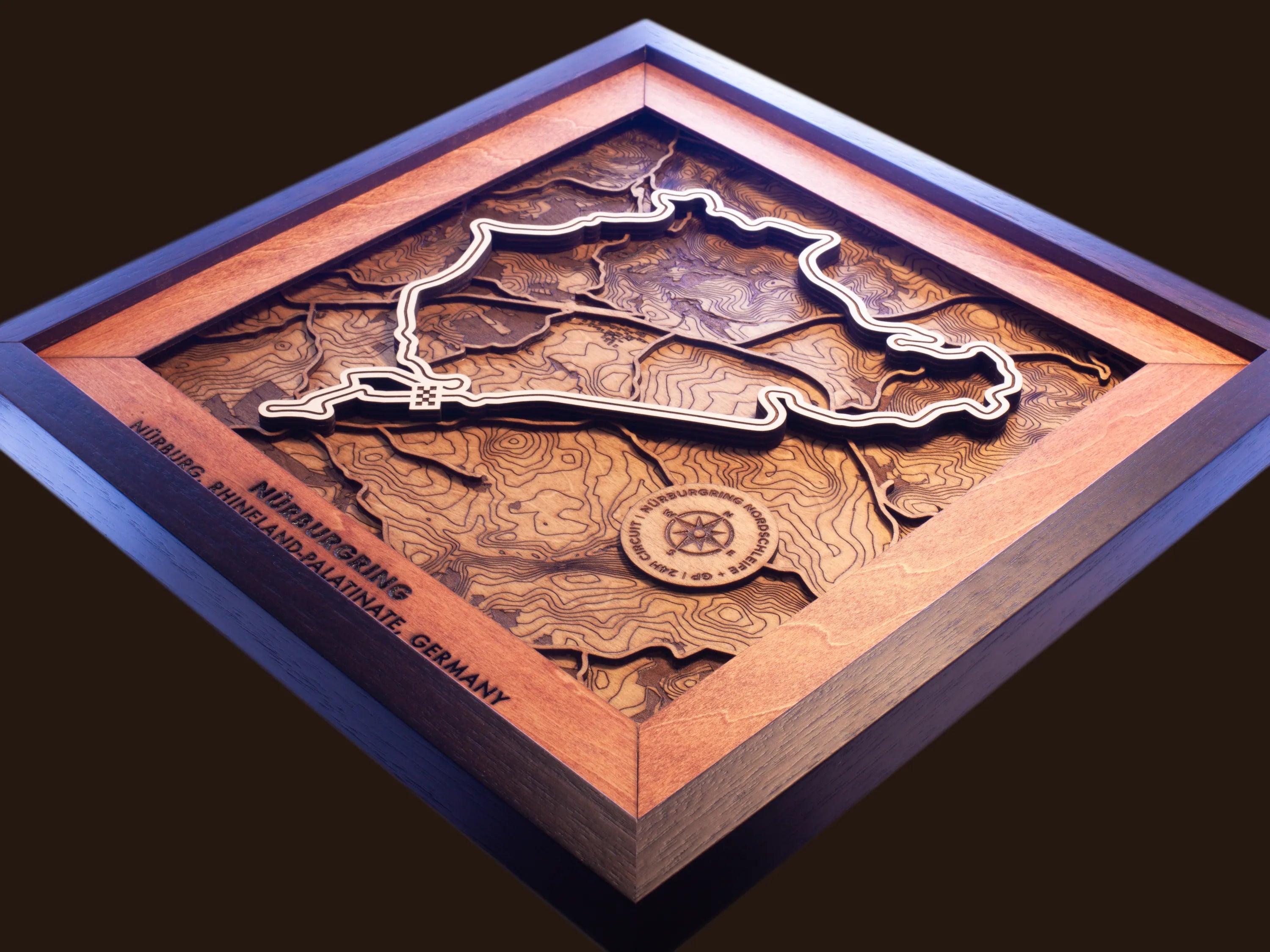 Close-up of the handcrafted layered wood construction and fine details of the NŸrburgring Nordschleife wall art.