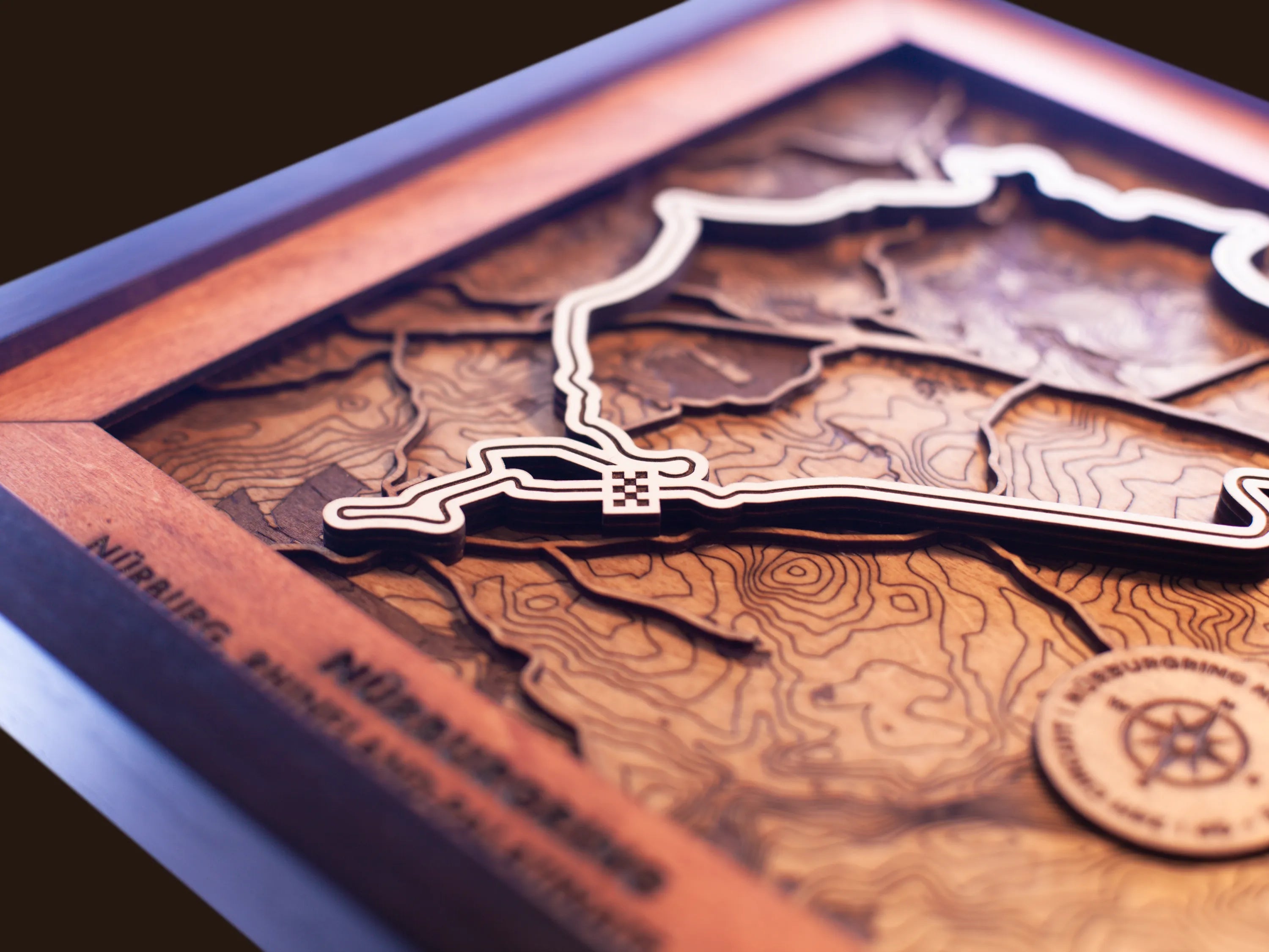 Close-up of the handcrafted layered wood construction and fine details of the NŸrburgring Nordschleife wall art.