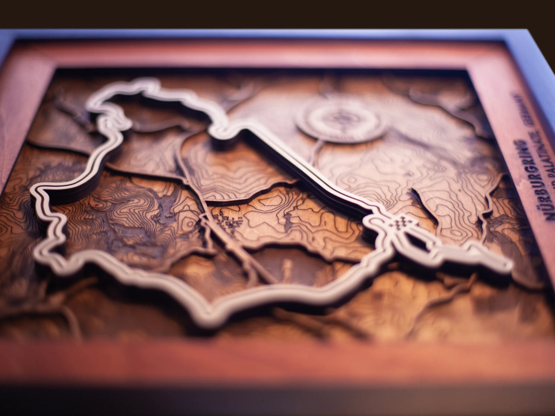 Close-up of the handcrafted layered wood construction and fine details of the NŸrburgring Nordschleife wall art.