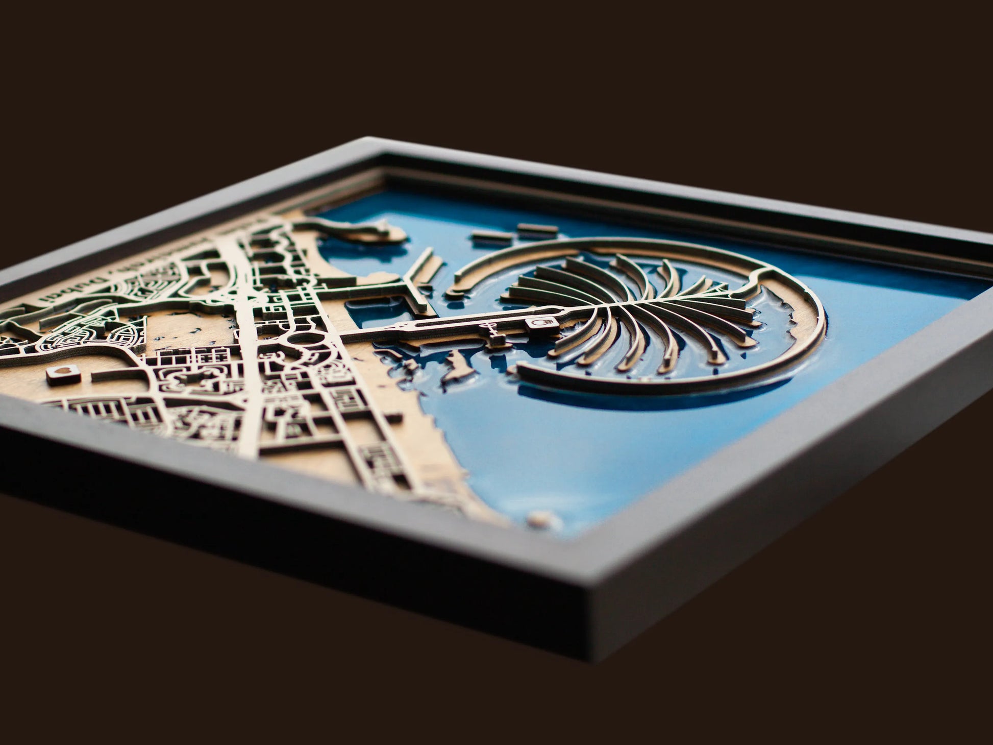 Close-up of the layered wood construction and precision laser engraving of the Palm Jumeriah wall art.