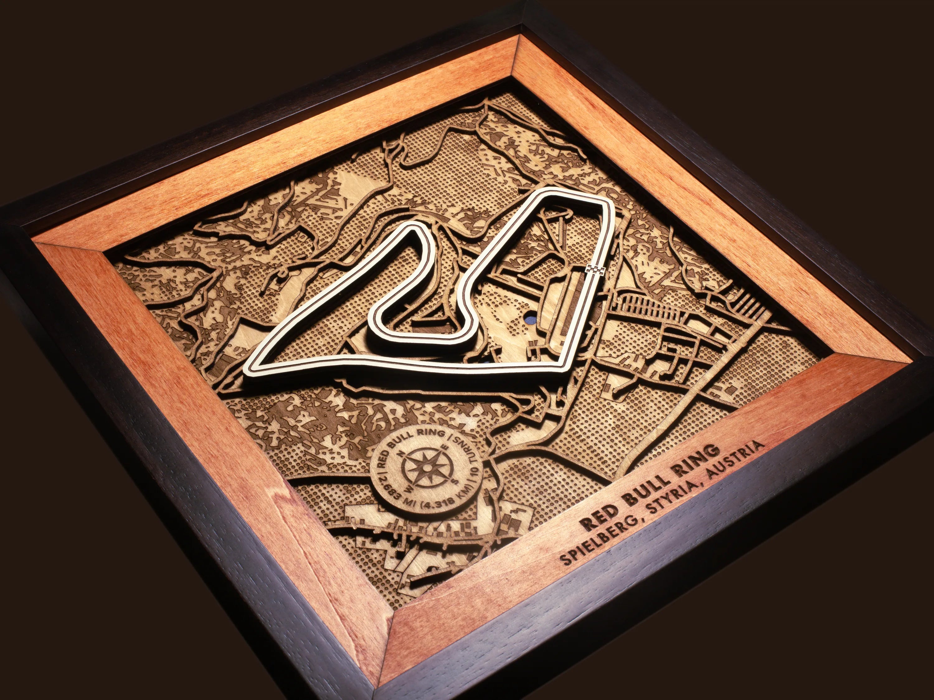 Close-up of the handcrafted layered wood construction and fine details of the Red Bull Ring wall art.