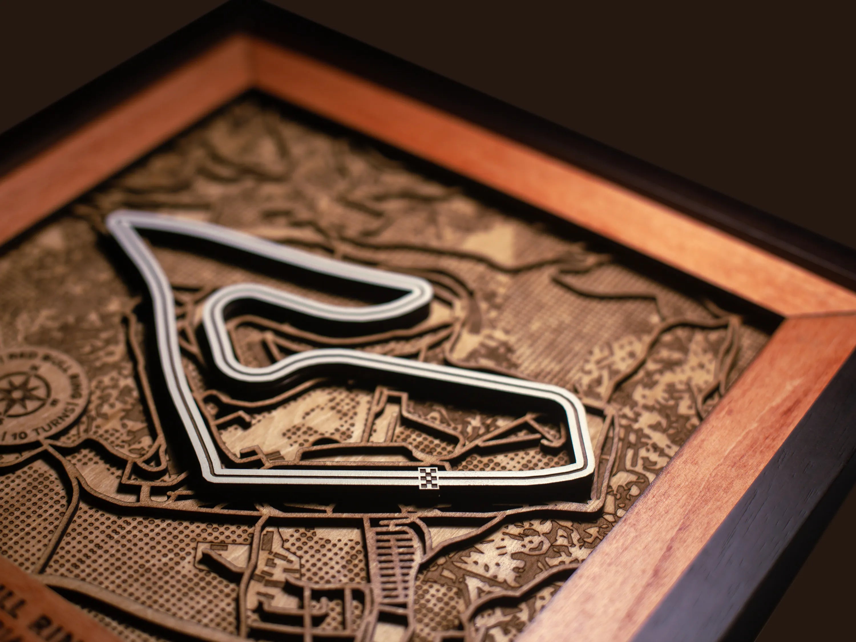 Close-up of the handcrafted layered wood construction and fine details of the Red Bull Ring wall art.
