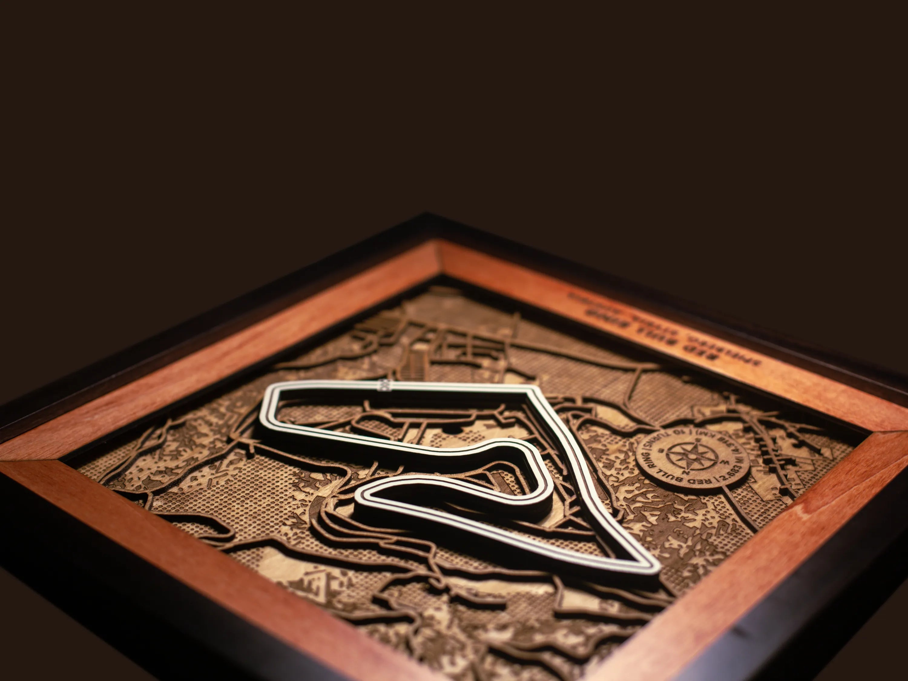 Close-up of the handcrafted layered wood construction and fine details of the Red Bull Ring wall art.